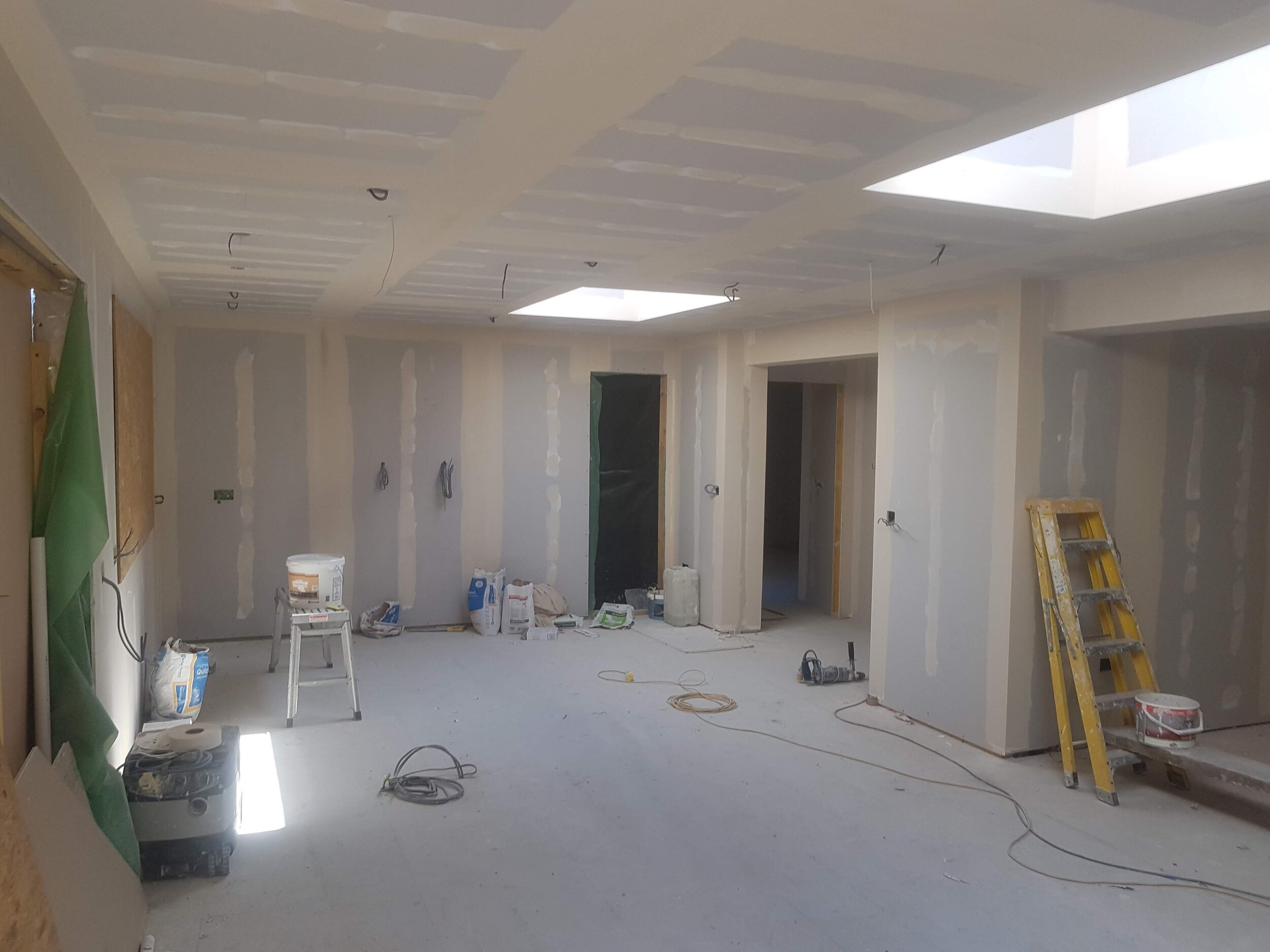 Room under construction with drywall and tools