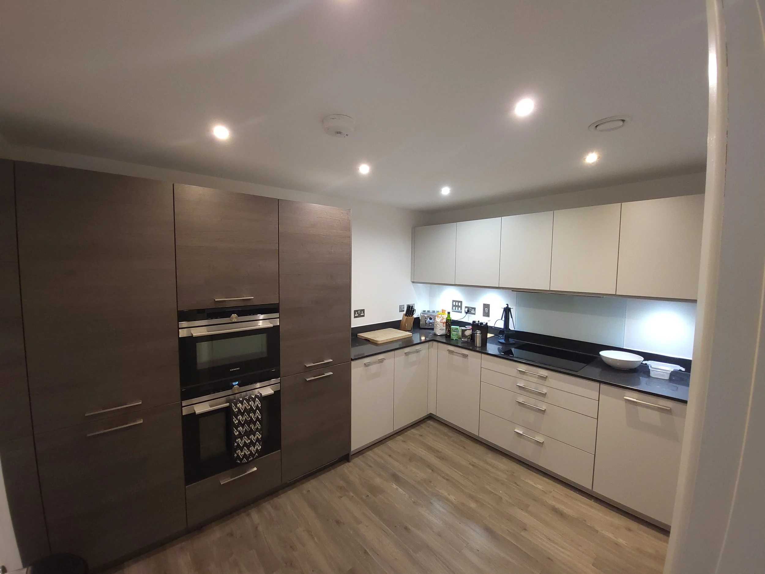 Modern kitchen with sleek cabinets, built-in oven, and countertop appliances.