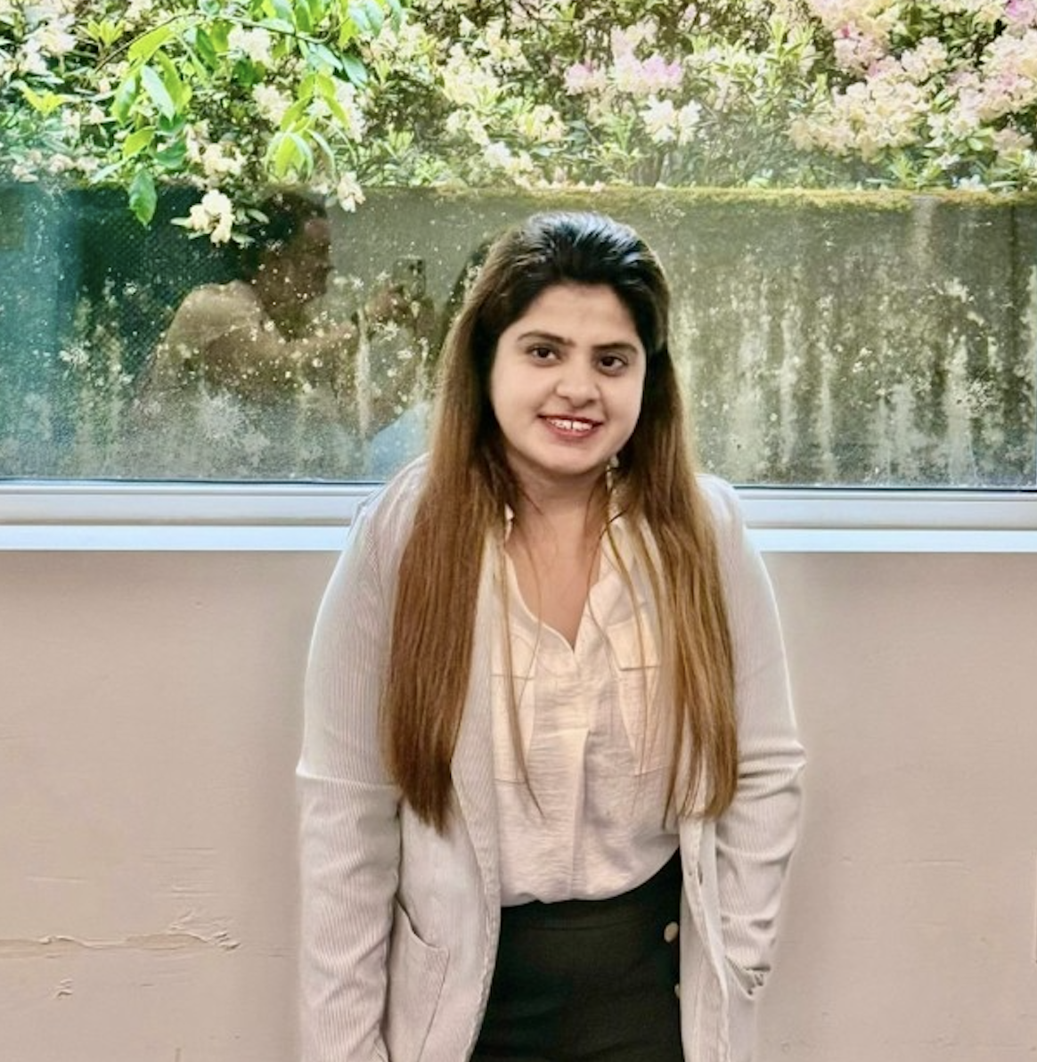 Faria standing in front of green foliage