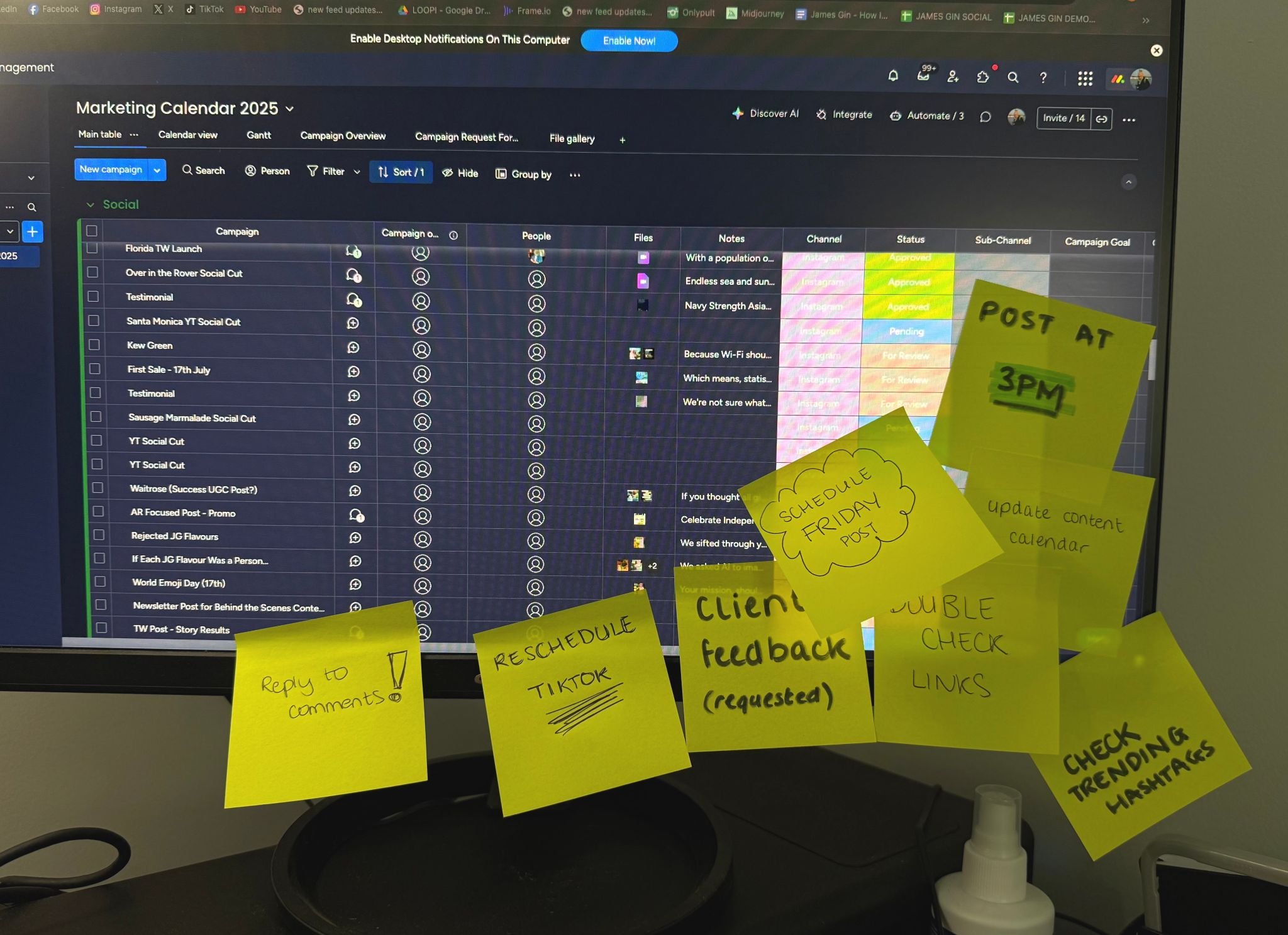 Computer monitor displaying a marketing calendar for 2025 with various social media campaign tasks. Several yellow sticky notes with handwritten reminders are attached to the monitor, including messages about scheduling, content updates, client feedback, and checklists.