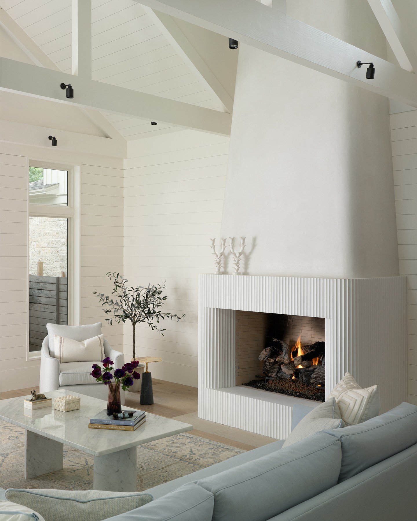 This fireplace is the perfect companion to the vent hood, echoing its curves while elevating the entire room. The original fireplace felt heavy and rigid, with a disproportionate stone mass stretching all the way to the ceiling, so we worked to creat