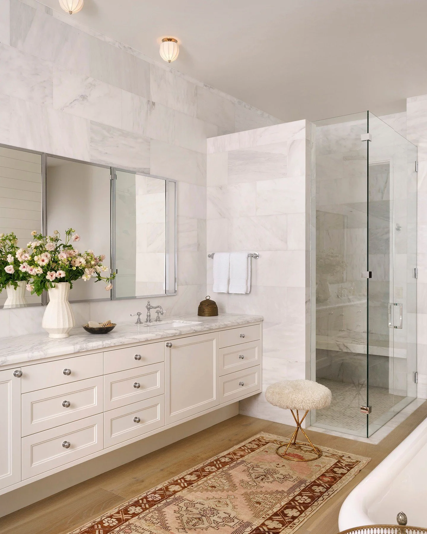 The beauty of a remodel is often found in the subtle calibration of function and feeling. By integrating expansive custom mirrors and medicine cabinetry, we introduced significant storage while maintaining the architectural rhythm of the stone walls.