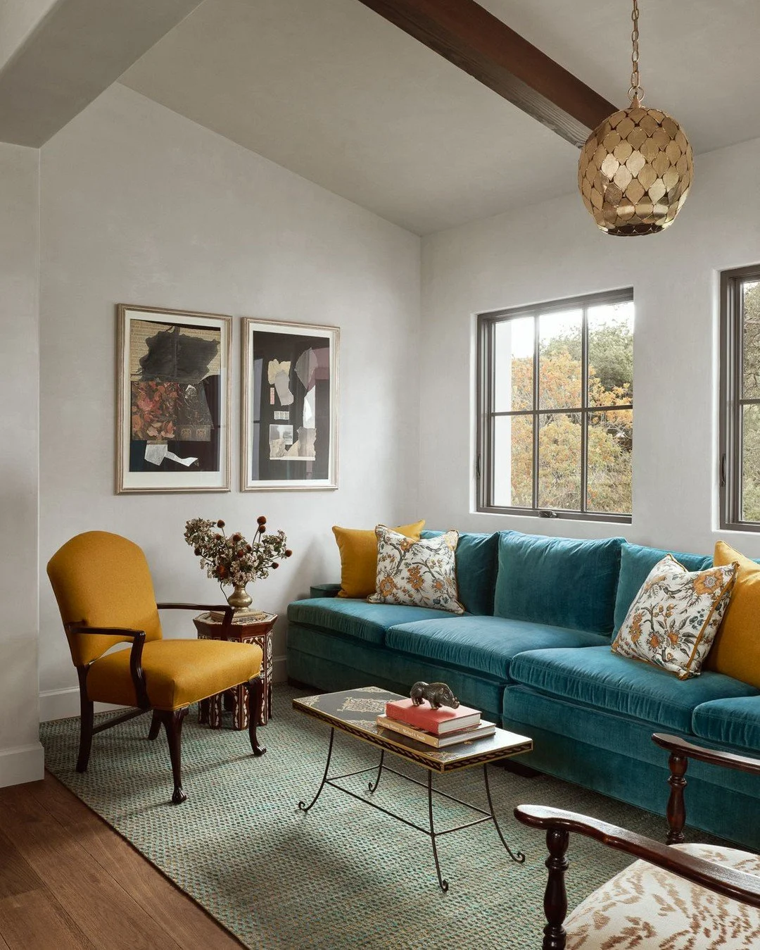 A room shaped by collection and care.

The banquette spans the full length of the space for reading, lounging, or gathering with friends. Recovered vintage pieces meet new designs in linen, wool, subtle animal print, and a custom contemporary rug &md