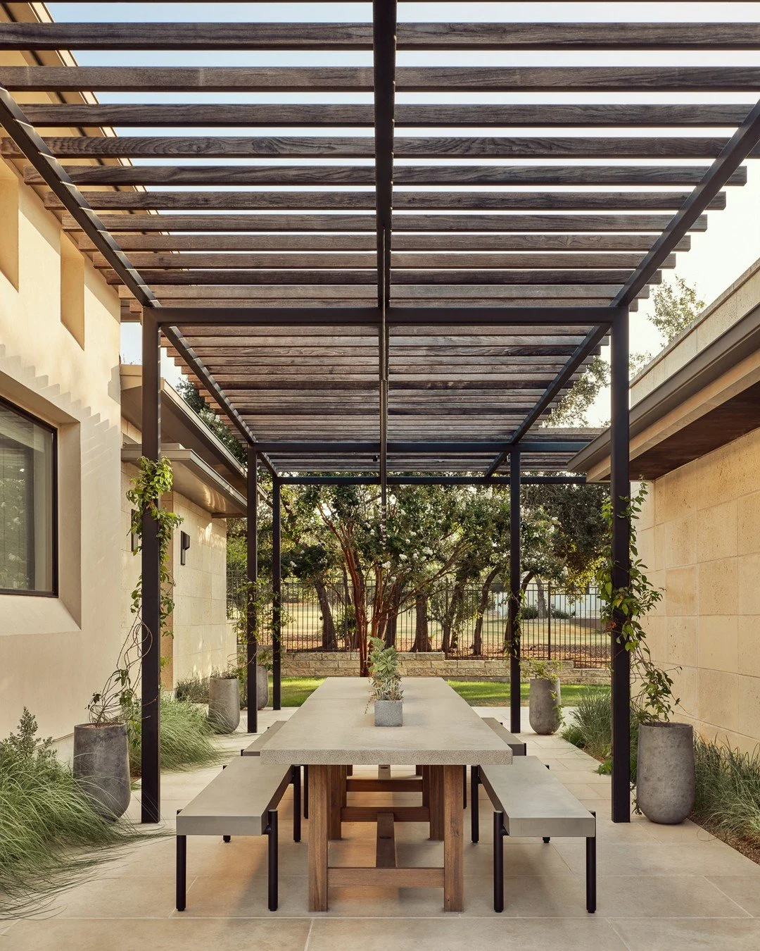 This outdoor space is designed around how these homeowners actually live outside.

With three main zones, it allows spending most of the time outdoors while still offering covered areas for comfort and shade. The dining space becomes the heart of it 