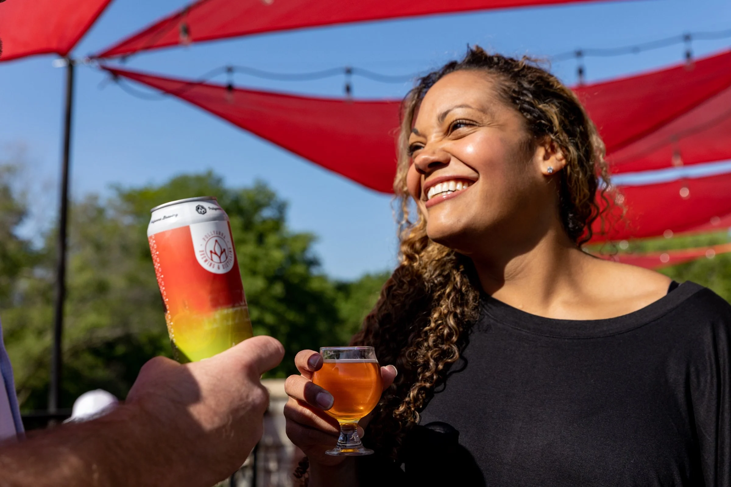 A photo of a craft beer enthusiast enjoying a beverage at the Pollyanna Brewing Company patio in Lemont Downtown, Illinois.