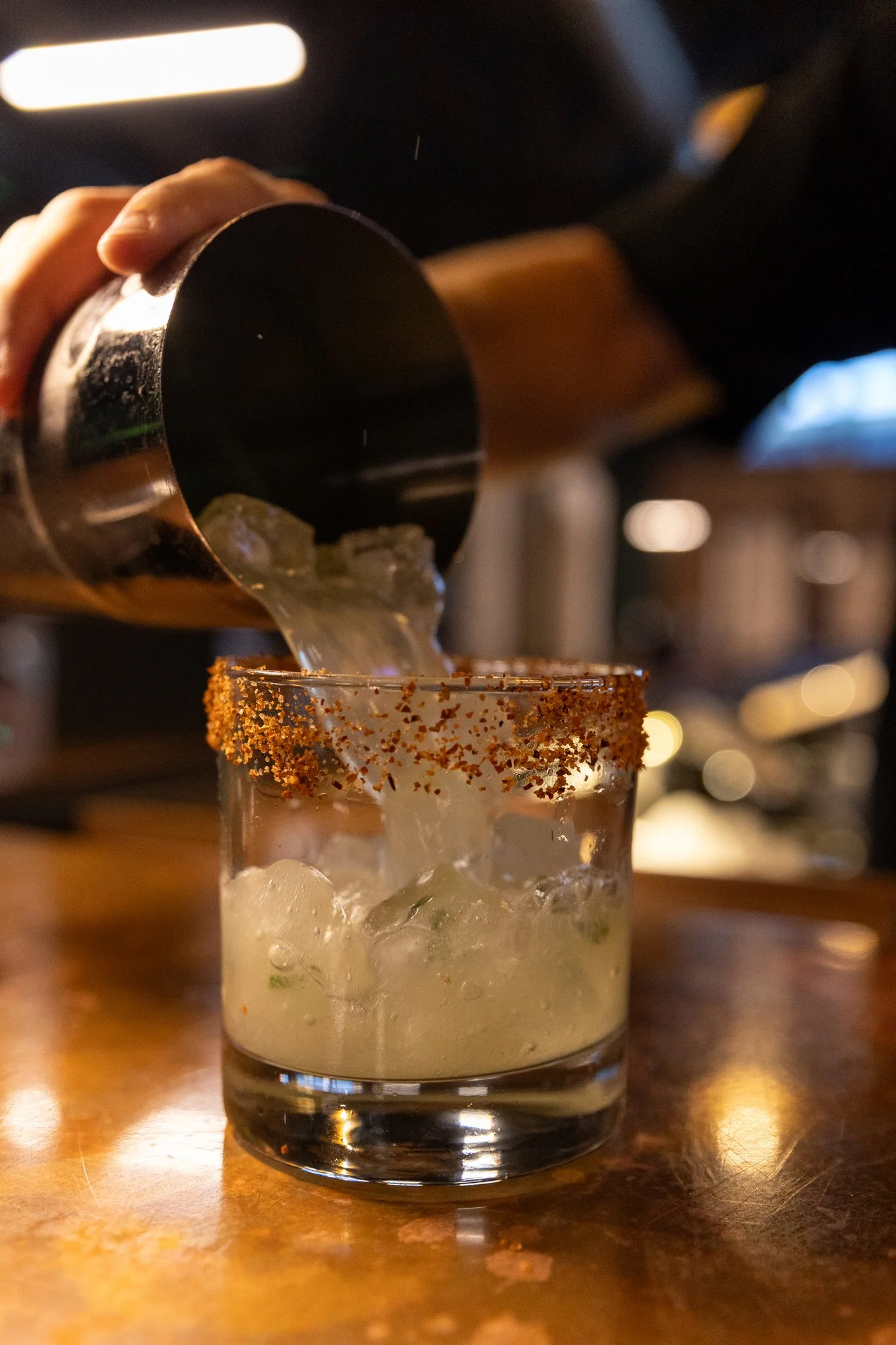 A photo of a bartender making a cocktail at The Club in Lemont, Illinois.