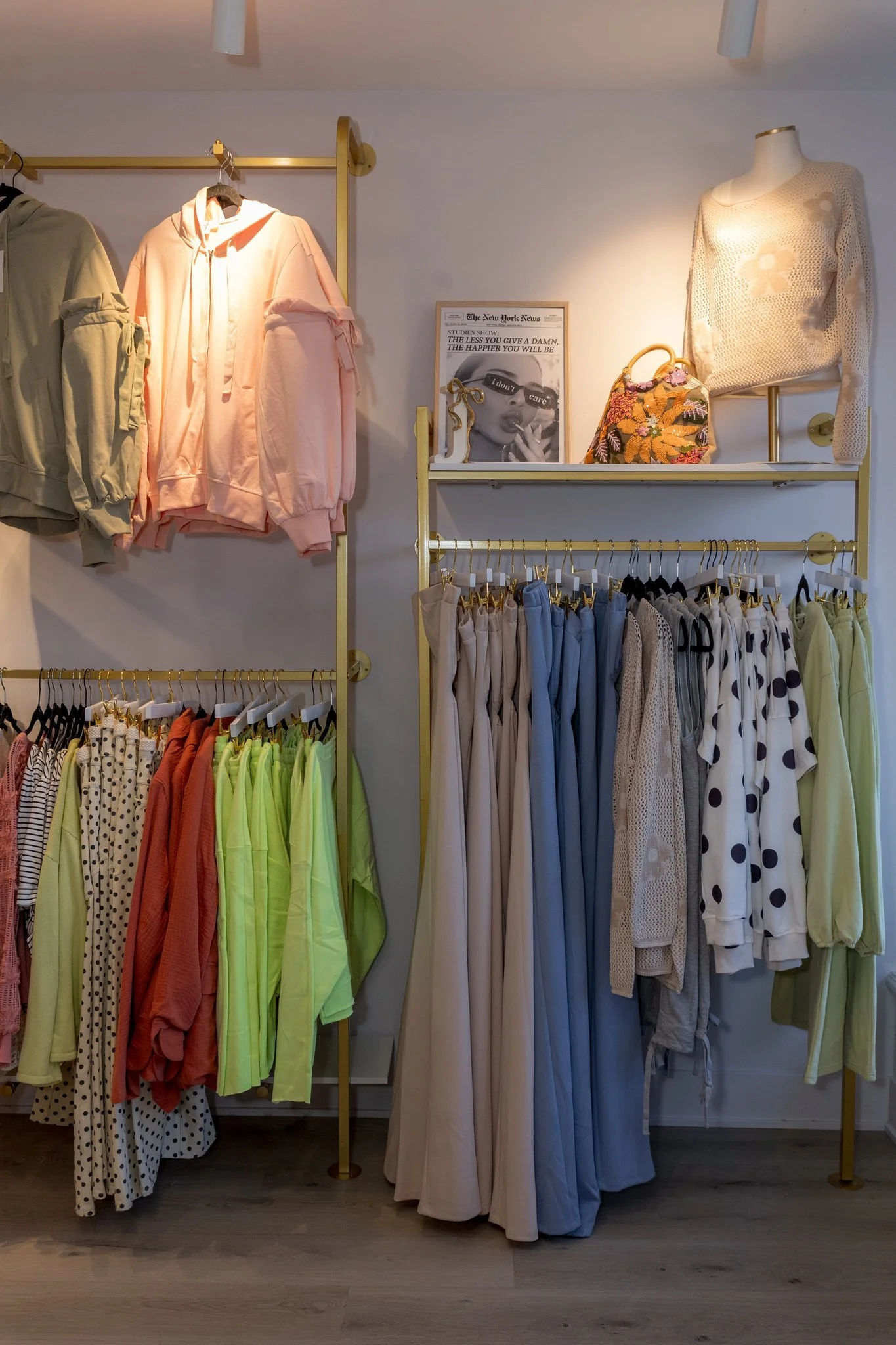 A photo of green and red sweaters, cardigans, bottoms, pants, tops, and jewelry available at Jaclyn Sue Boutique in Lemont Downtown, Illinois.