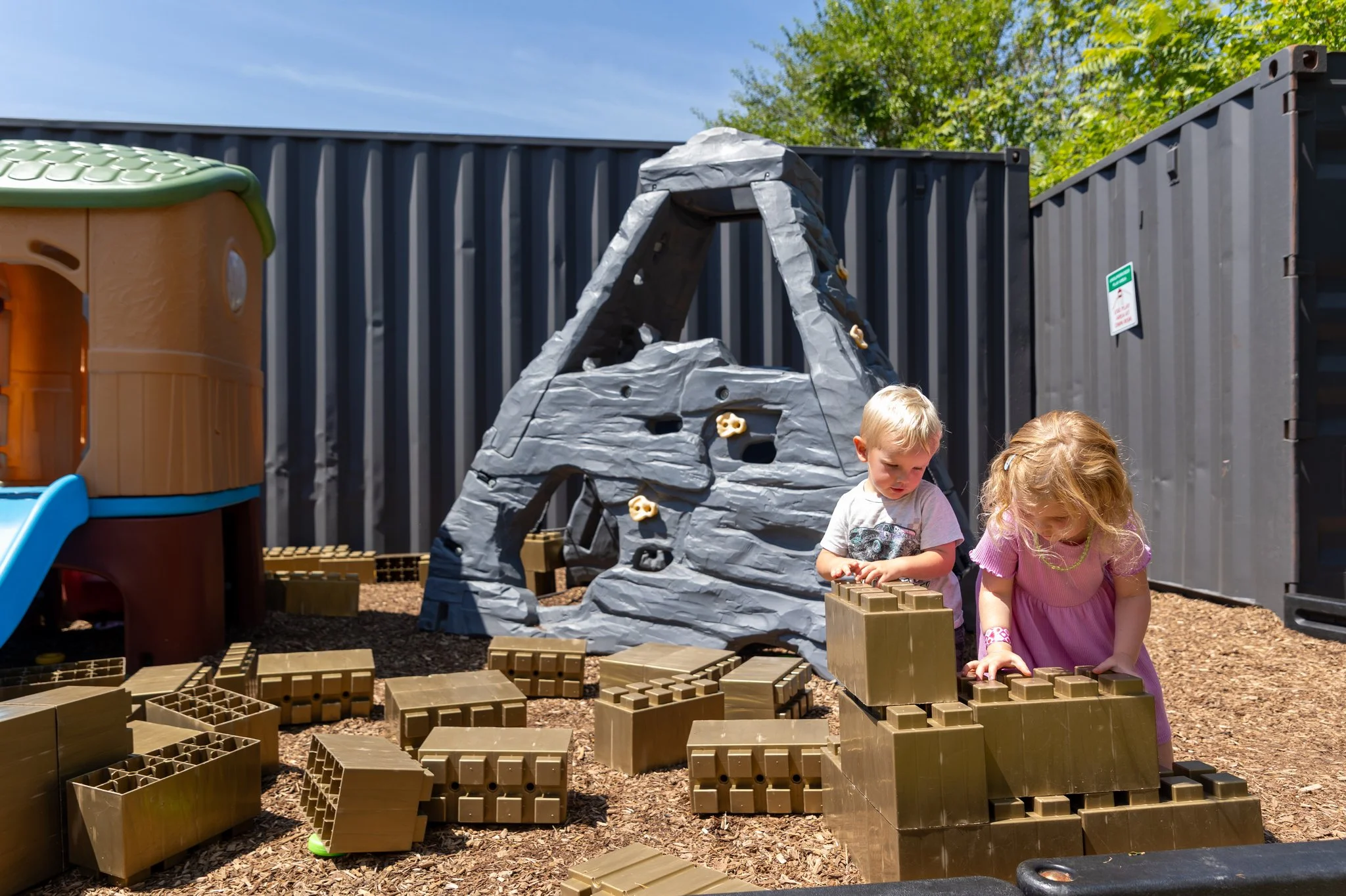 A photo of two kids playing on the patio at The Club in Lemont, Illinois.