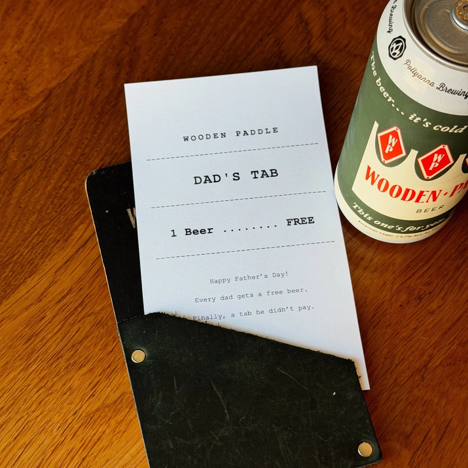 A photo of a tab for a dad on Father's Day at Wooden Paddle, where they receive a complimentary beer. Wooden Paddle is a restaurant in Lemont, Illinois.