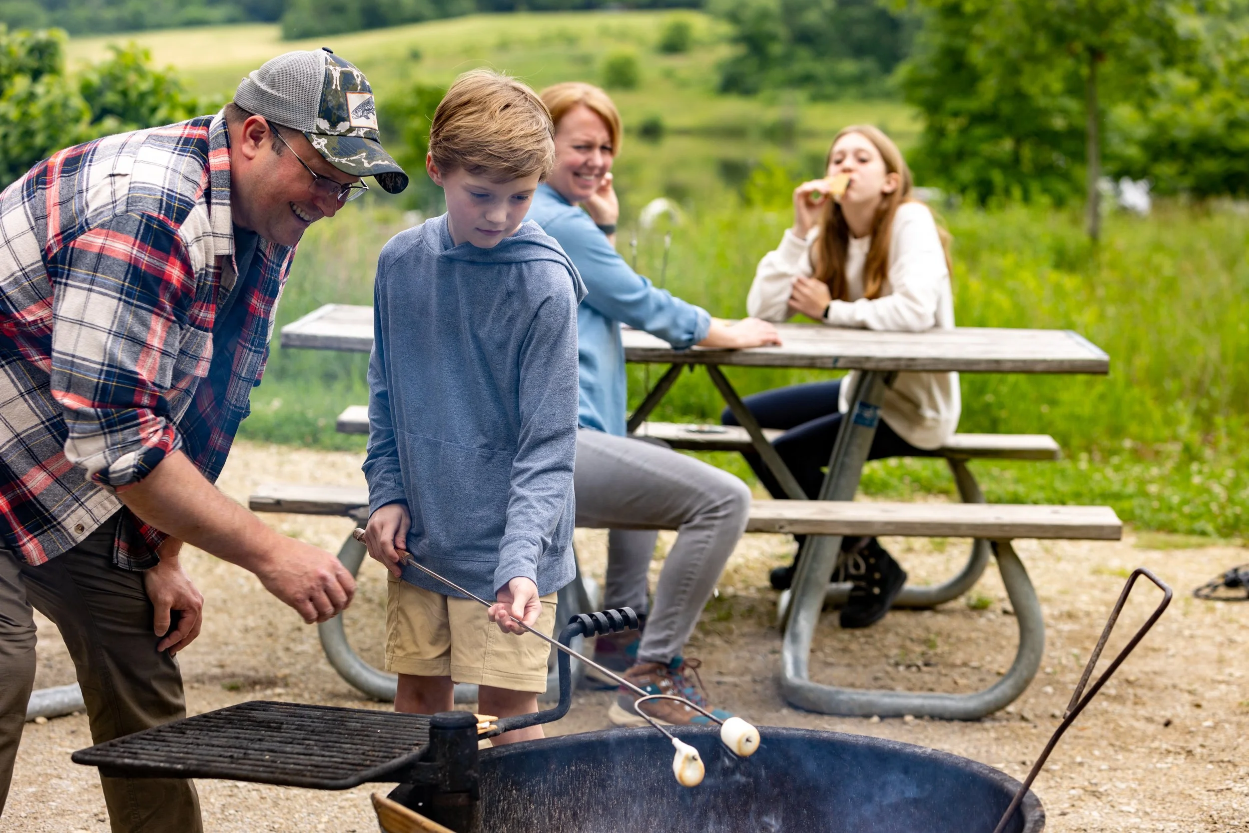 A photo of a father, son, mother, and daughter at Camp Bullfrog Lake, close to Lemont Downtown, Illinois.