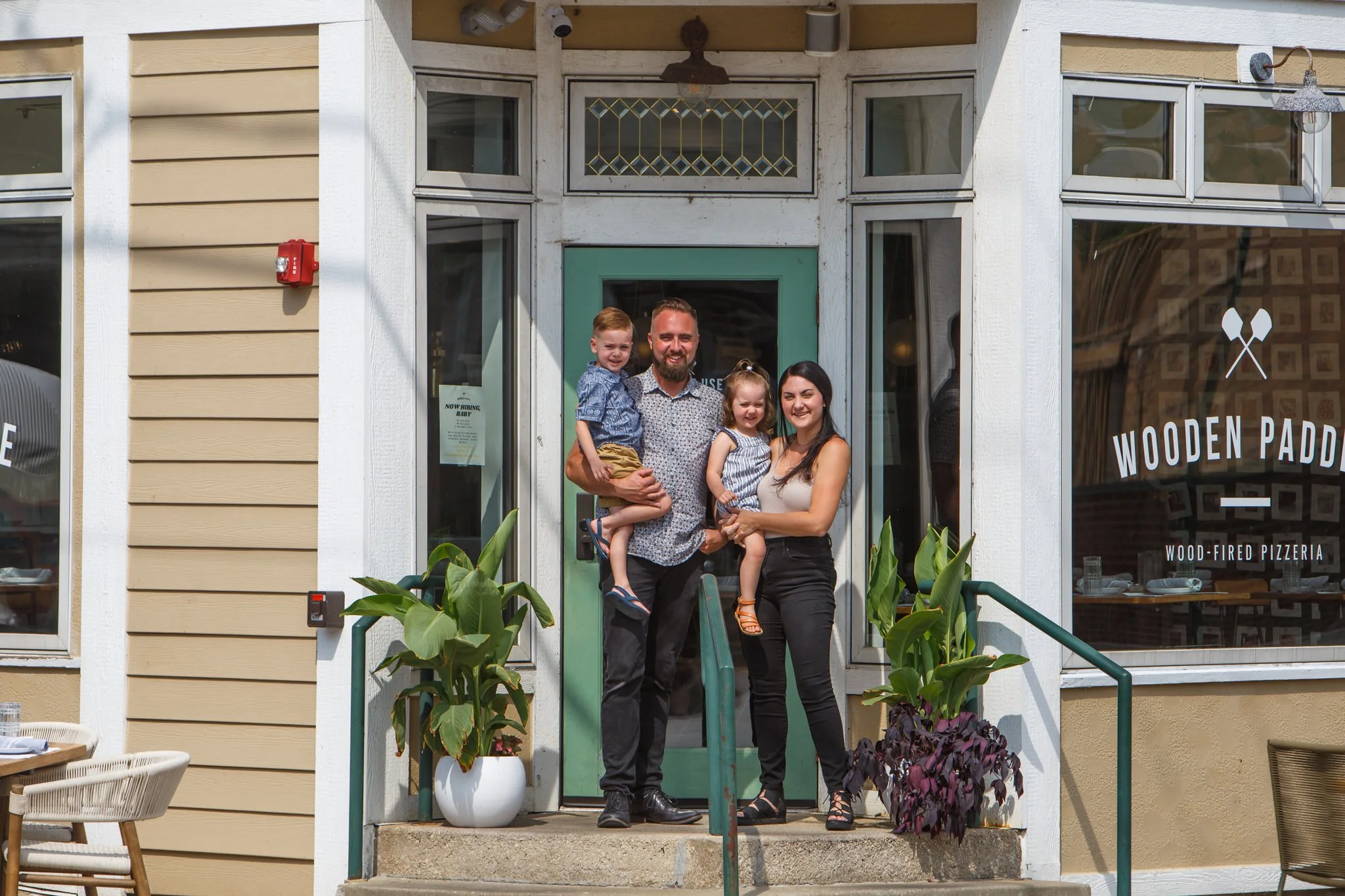 A photo of Wooden Paddle co-owners and their family in Lemont Downtown, Illinois.
