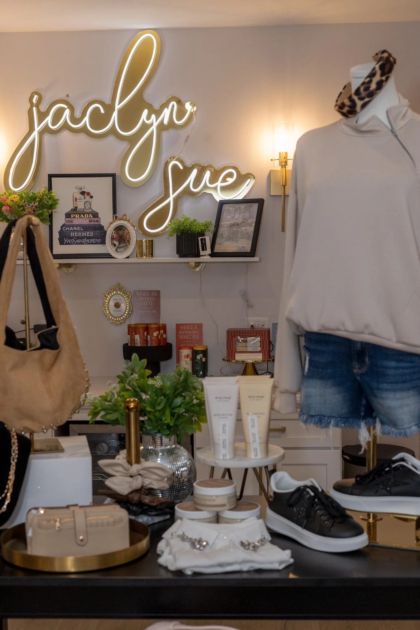 A photo of purses, shoes, sweaters, cardigans, bottoms, pants, tops, and jewelry available at Jaclyn Sue Boutique in Lemont Downtown, Illinois.