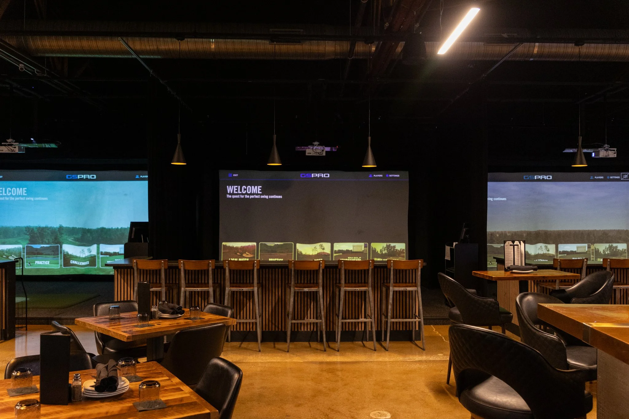 A photo of three big screens to watch sports games at The Club in Lemont, Illinois.