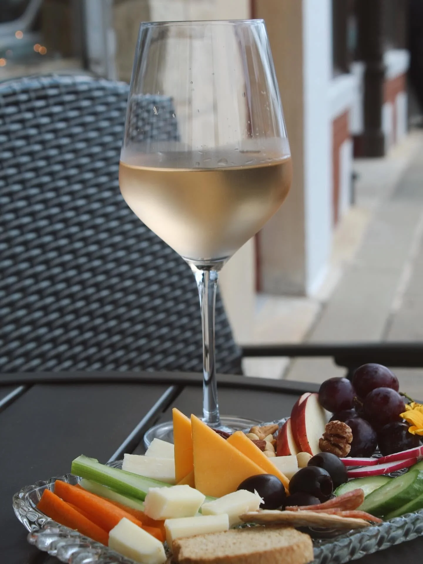 Photo of a glass of wine and cheese plate at One Eleven Wine & Partini Parlour in Lemont Downtown, Illinois.