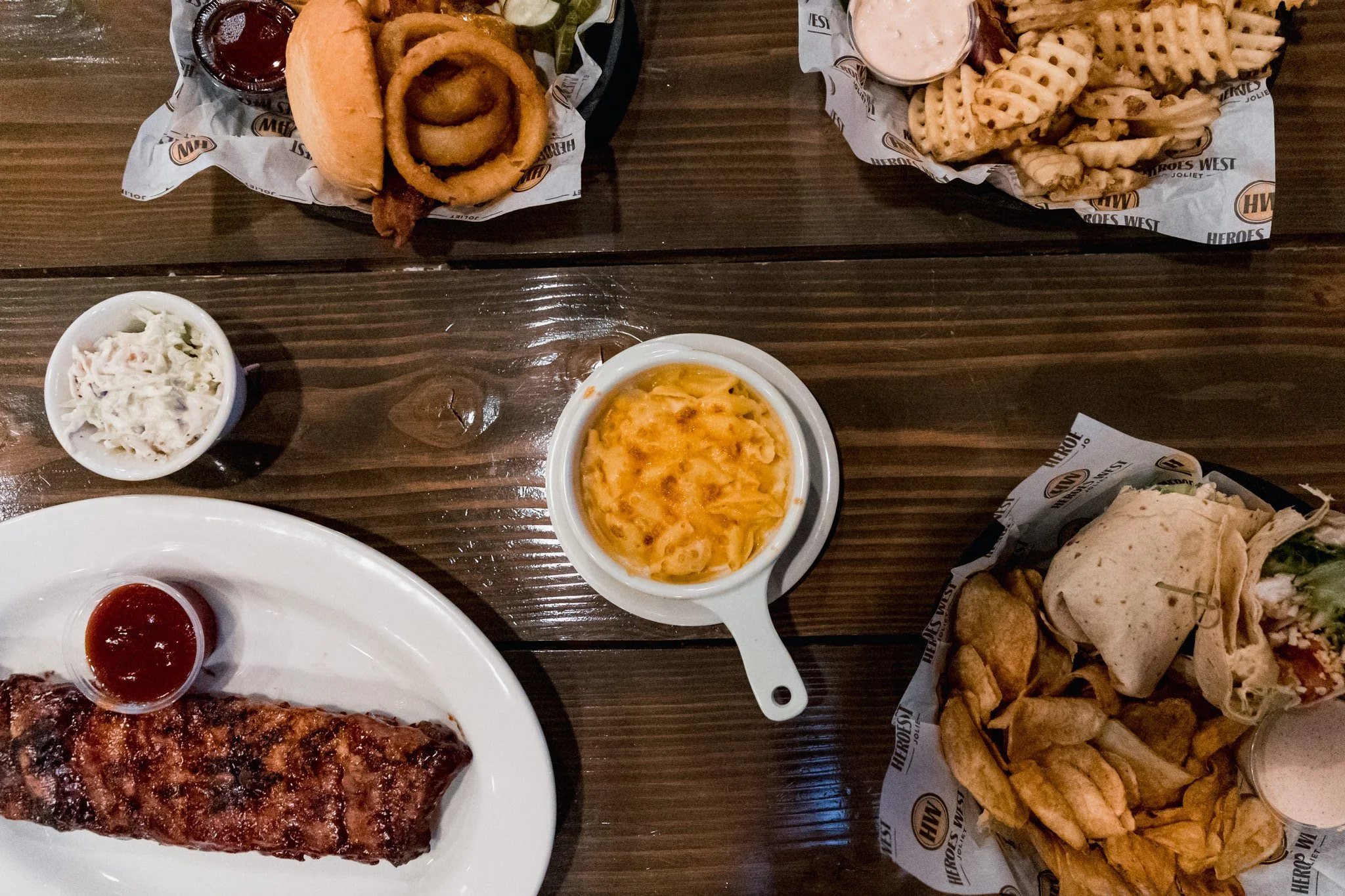 A photo of ribs, mac and cheese, wrap, chips, coleslaw, onion rings, waffle fries at Heroes West Lemont in Lemont Downtown, Illinois.