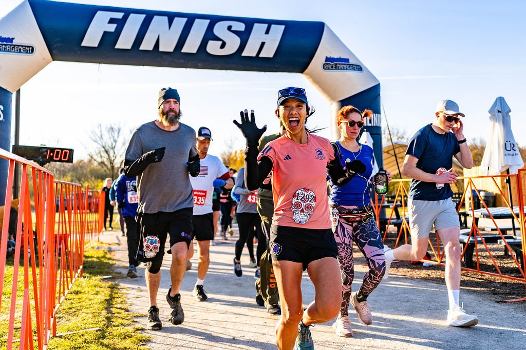 A photo of six runners crossing the finish line at Quarryman Race in Lemont Downtown, Illinois.