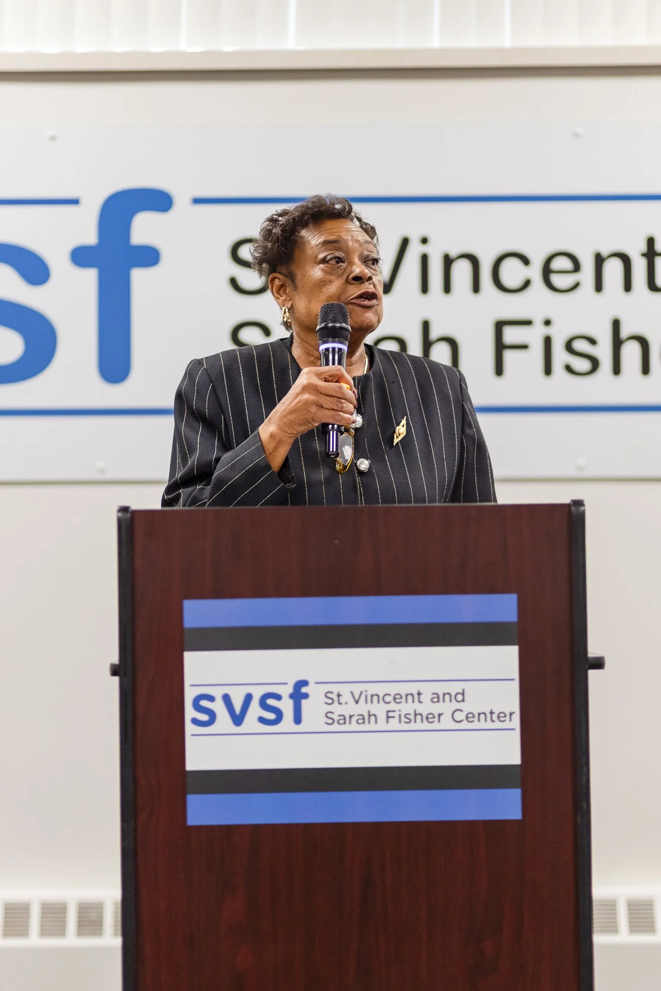Woman Speaking at a Podium: Nonprofit Event Photography Houston