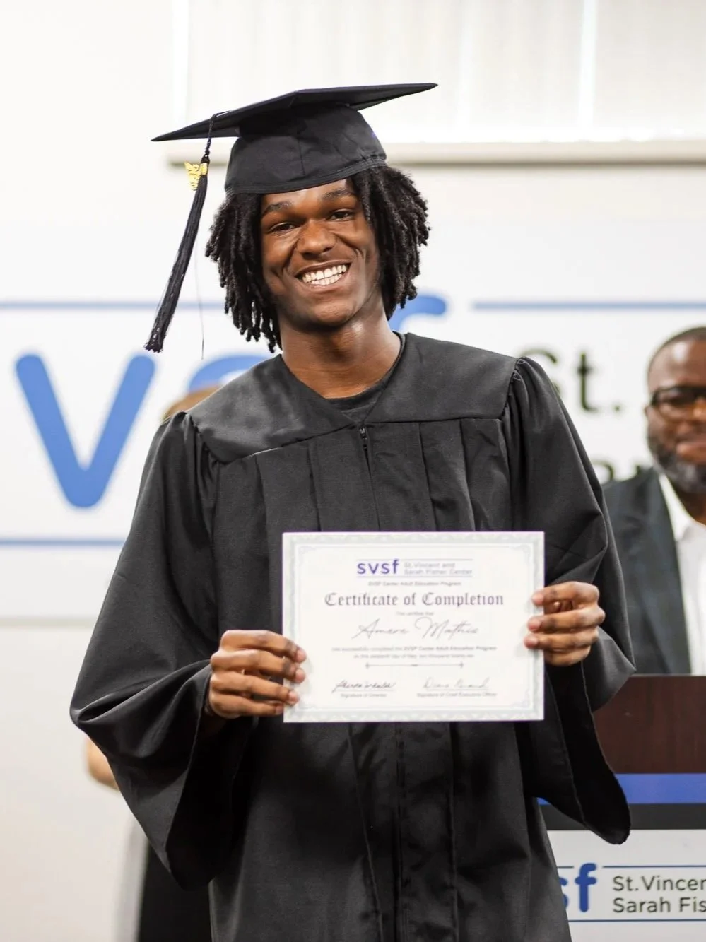 A man holding a diploma: Nonprofit Event Photography Houston