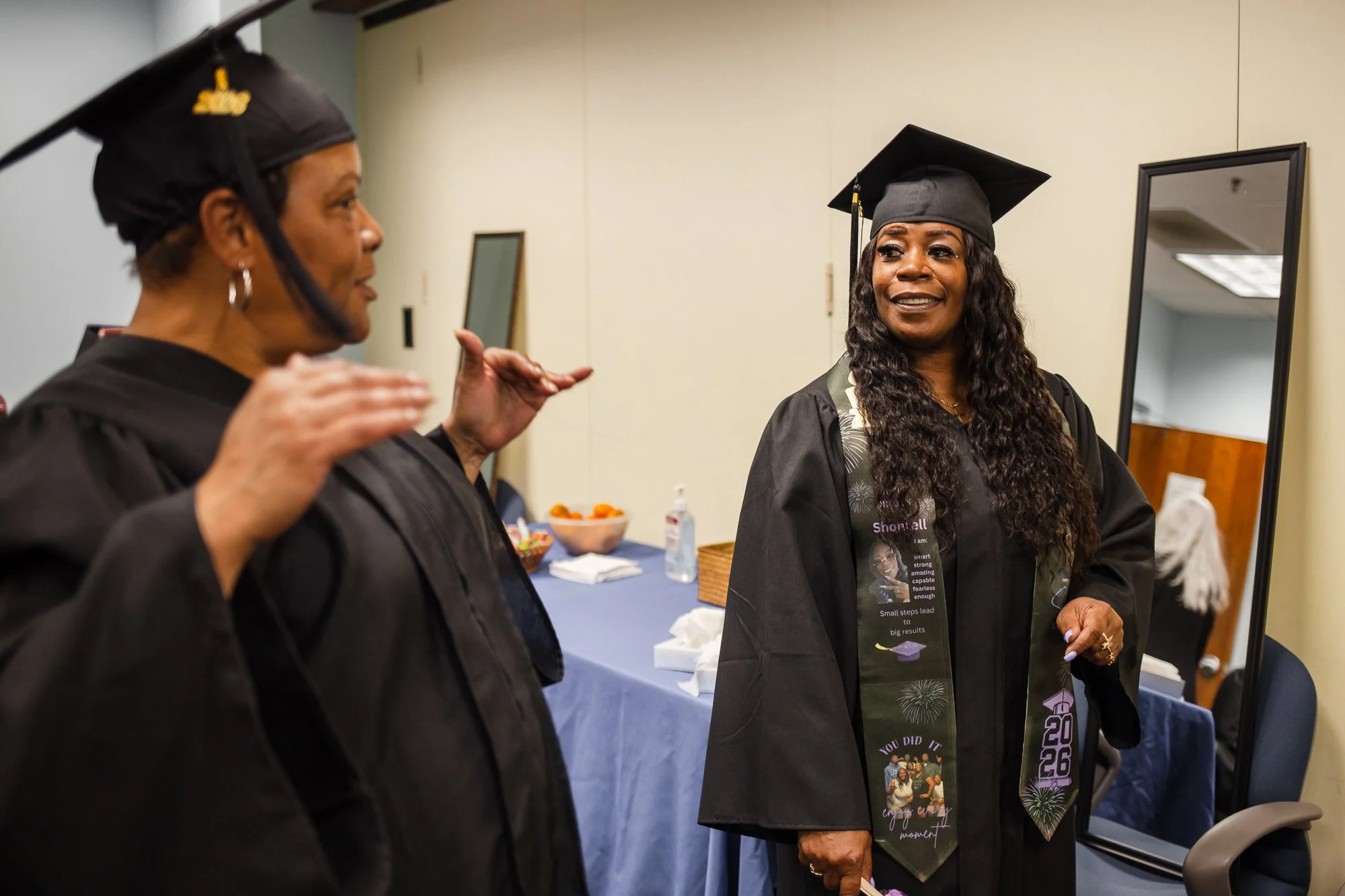 Two graduates talking: nonprofit graduation ceremony Detroit event photography.