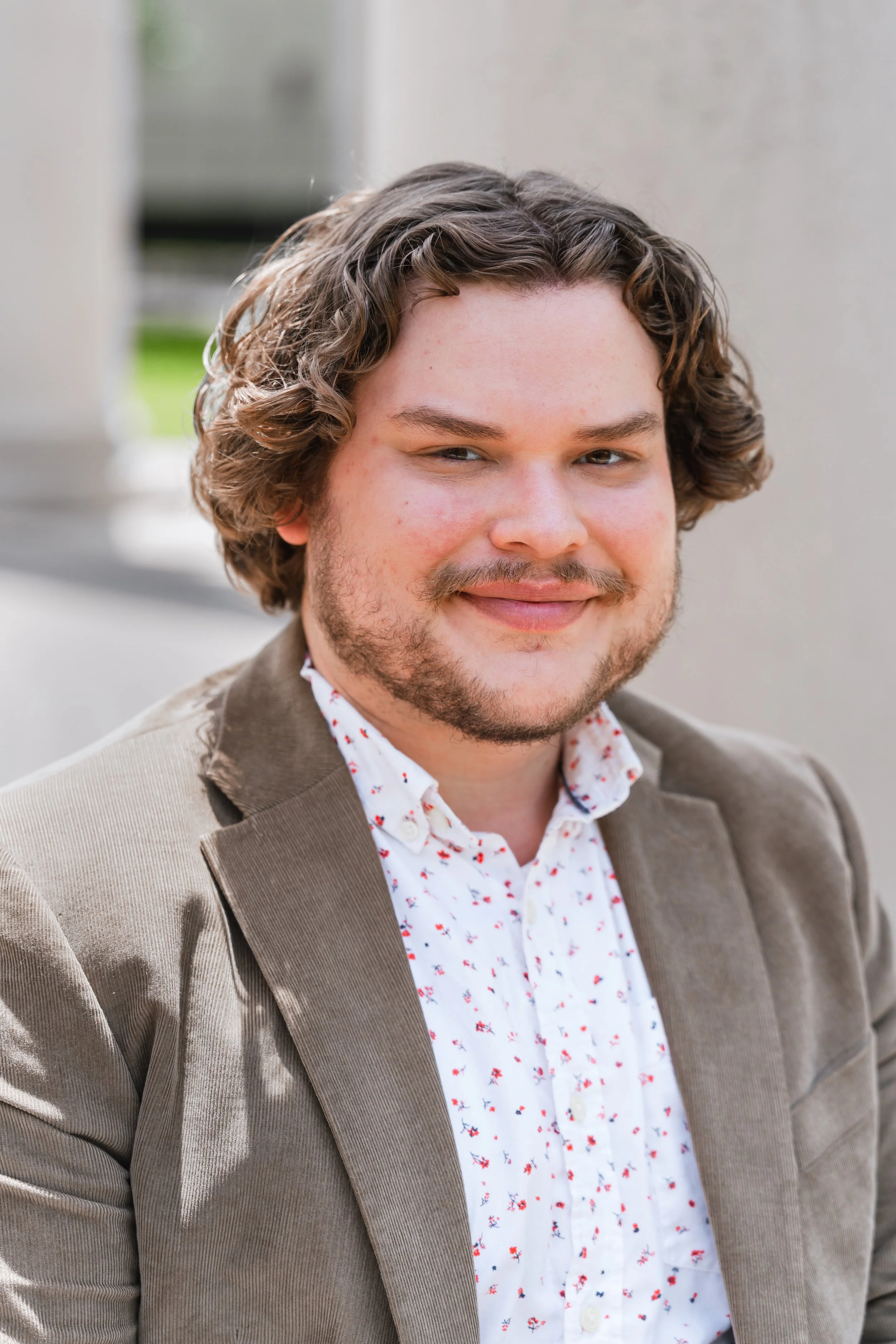 A headshot of a man smiling