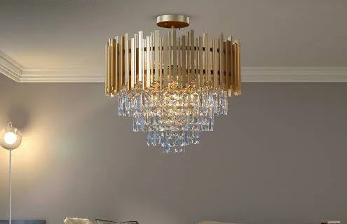 A luxurious crystal chandelier with a gold rim hanging from a ceiling in a modern room.