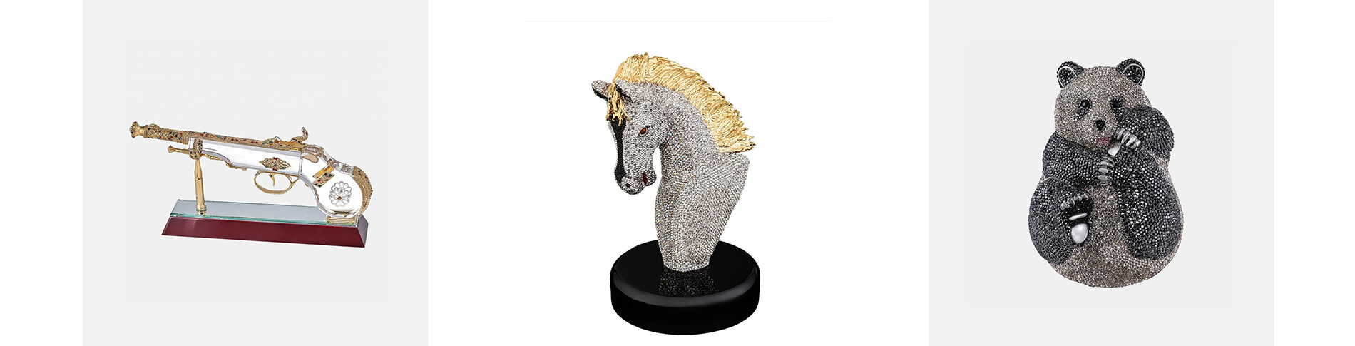 Three decorative items: a jeweled gun, a diamond-studded horse head sculpture, and a diamond-studded bear sculpture.