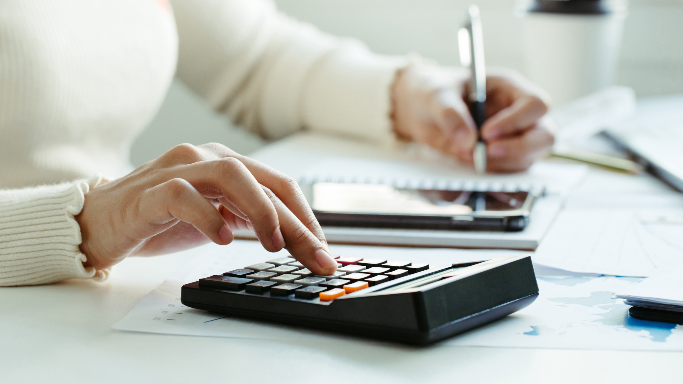 woman typing on a calculator