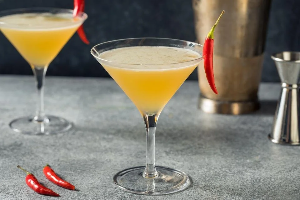 Cocktail in martini glass with Calabrian chili peppers