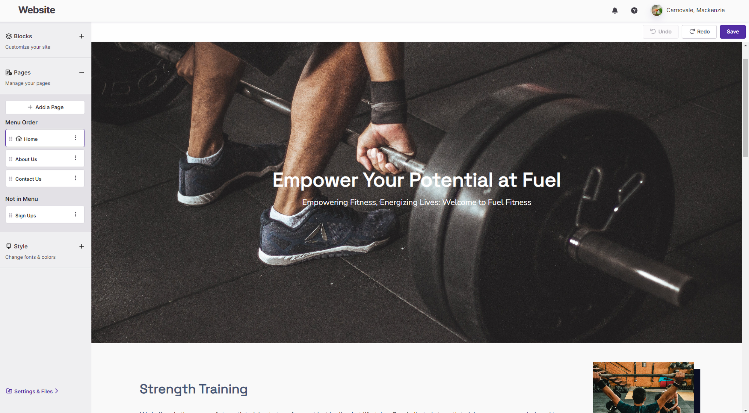 A person lifting a barbell with weights in a gym. The focus is on their legs, shoes, and hand gripping the barbell, with gym flooring visible.