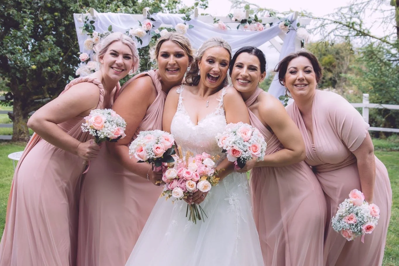 Bride with her bridesmaids in pink