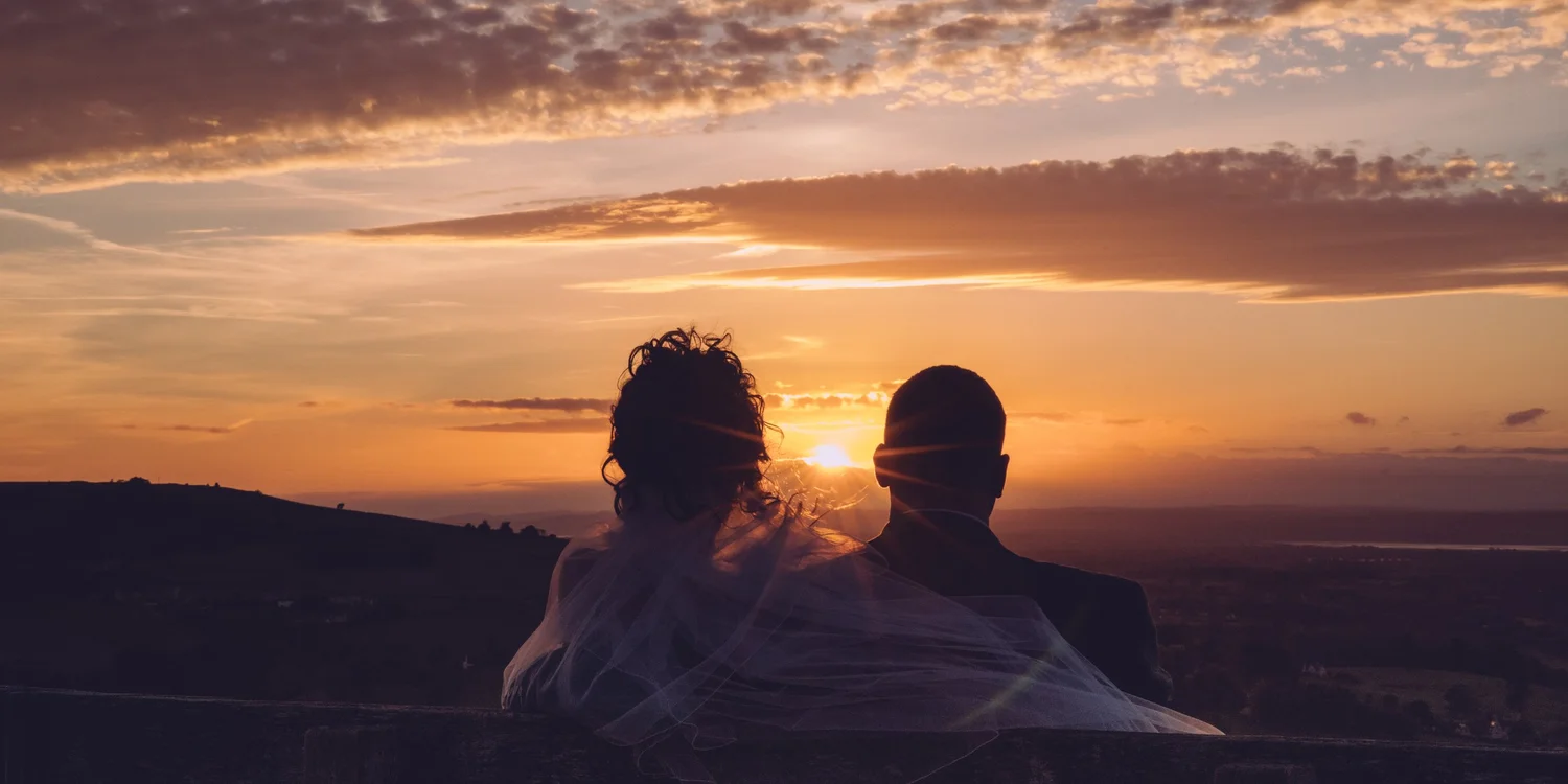 Couple watching the sunset over the Cotswolds