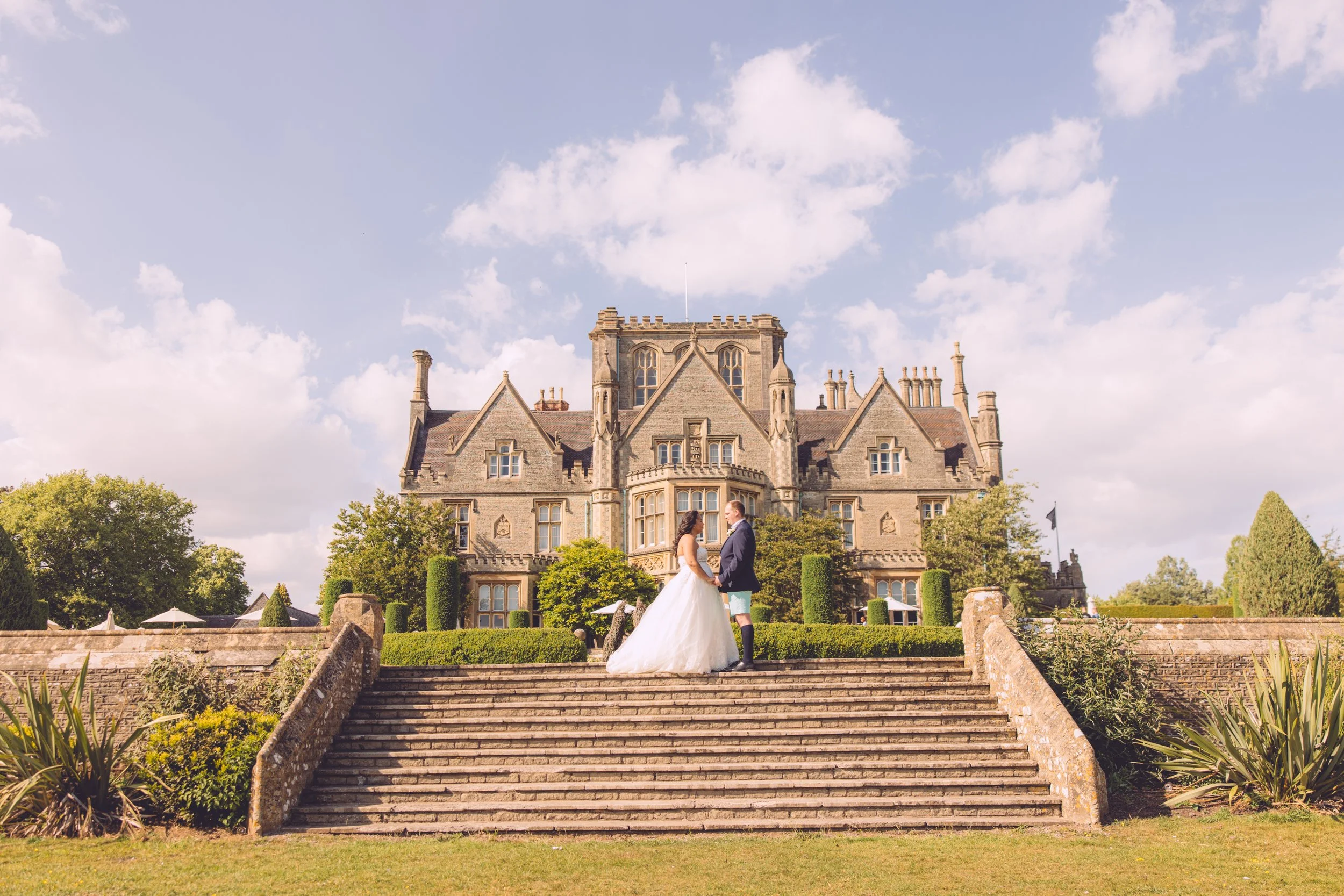 Bride and groom on the steps at Tortworth Court