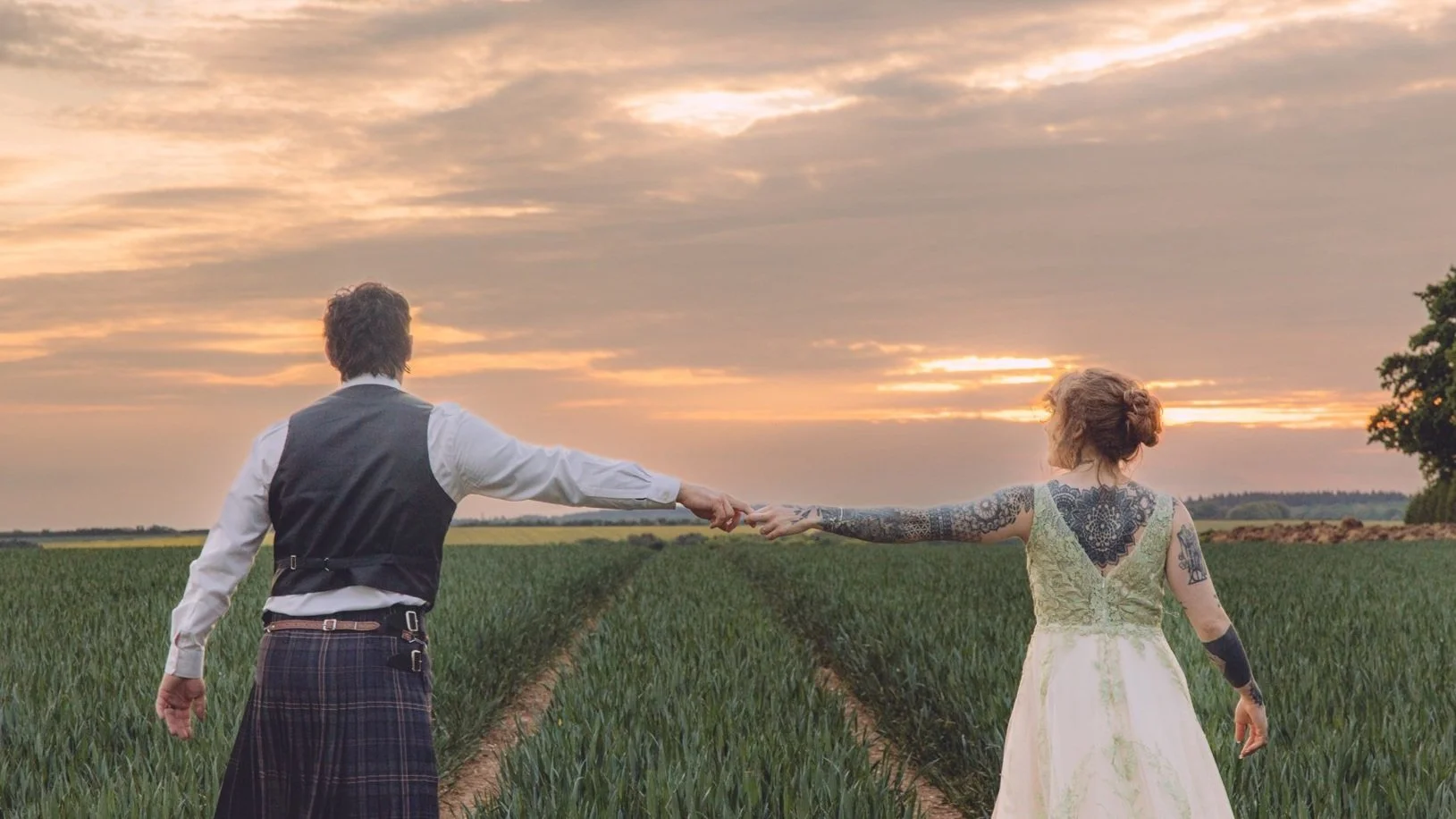 Couple walking through a field at The Woods at Oakley