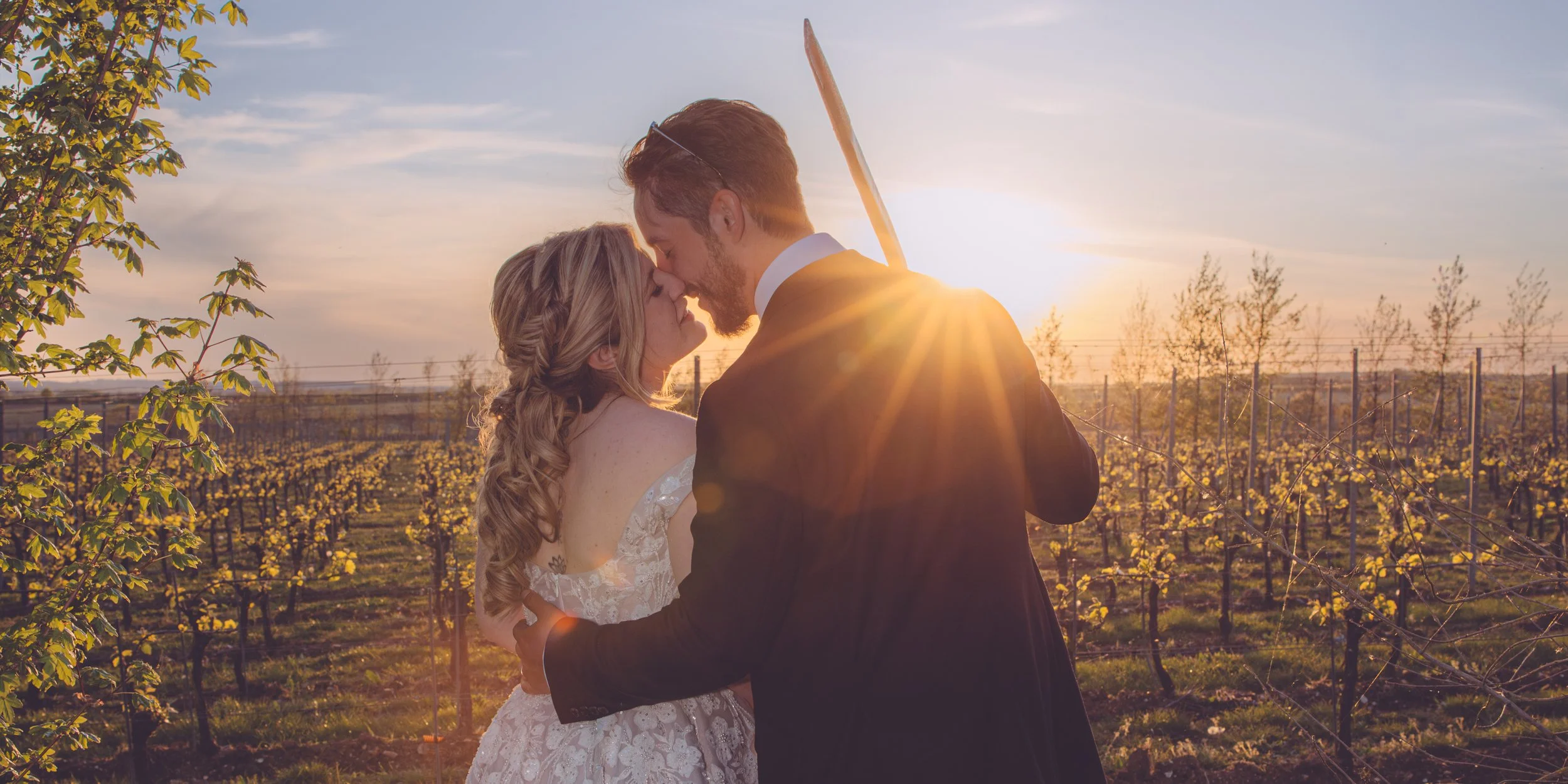 Couple kissing at golden hour at Pinglestone Barn — documentary wedding photography by Captured by Chris