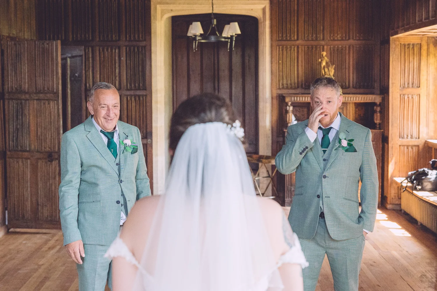 Groomsmen reacting as the bride walks in