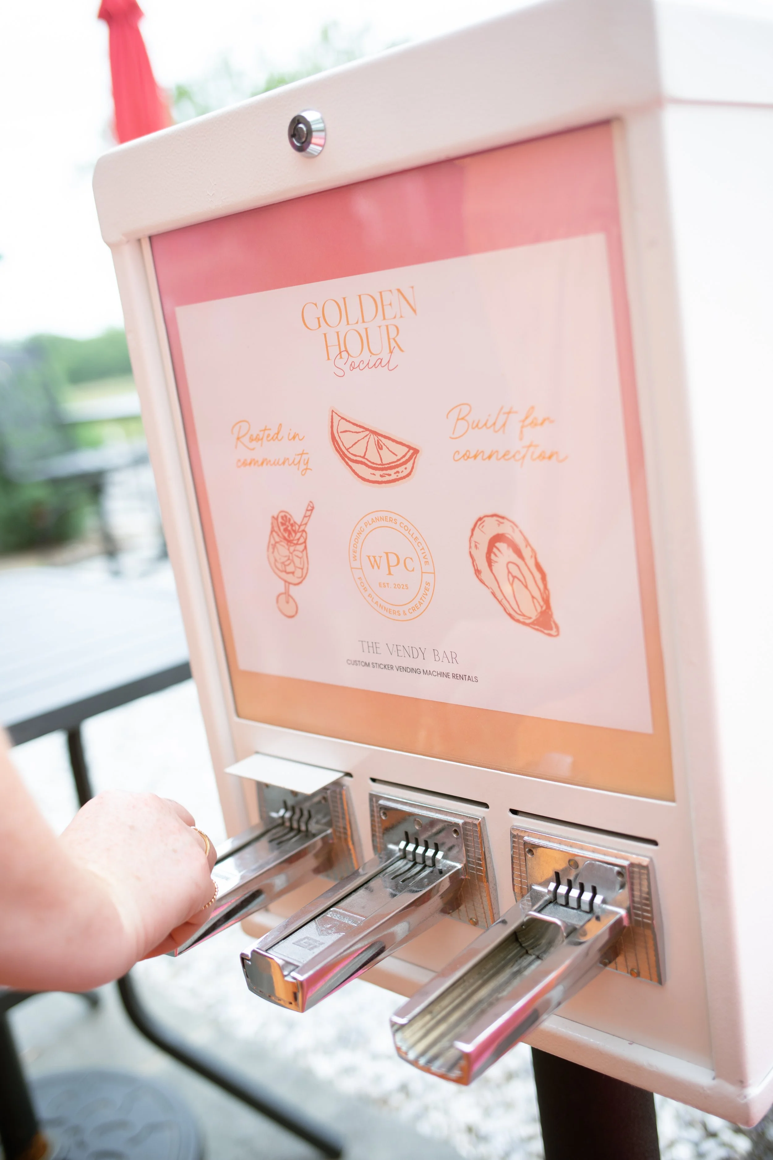 Guest using Vendy Bar's custom sticker vending machine at The Wedding Planners Collective's Golden Hour Social in Wallkill, New York.