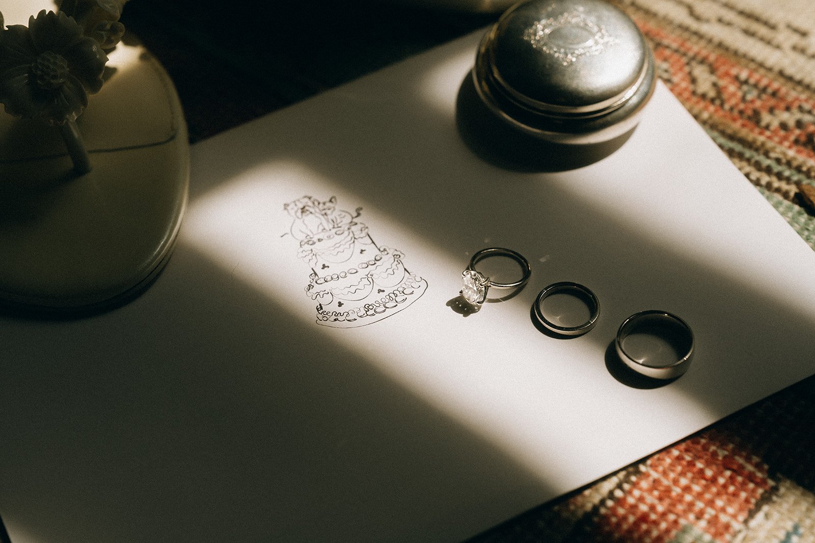 Black and white photo of people dining at a long table, with plates, glasses, and candles.