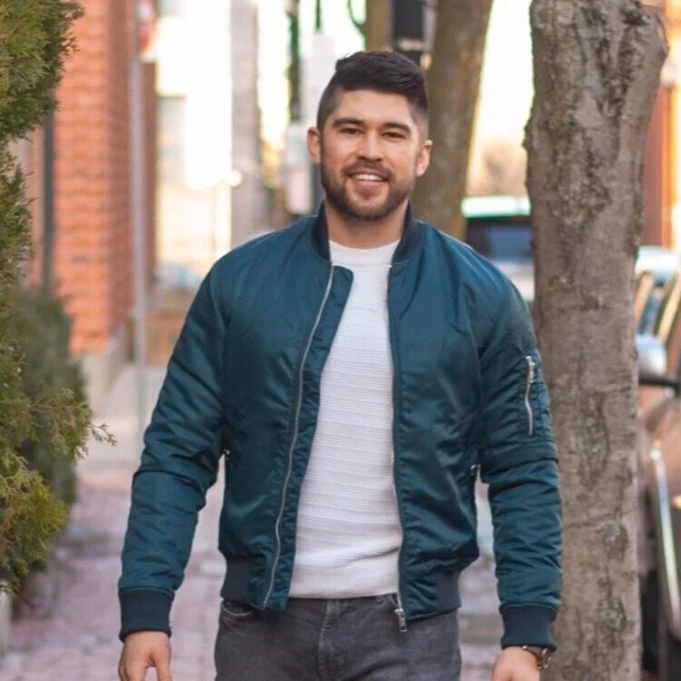 Bright natural dining room nook with vases plates and fruits on the table.