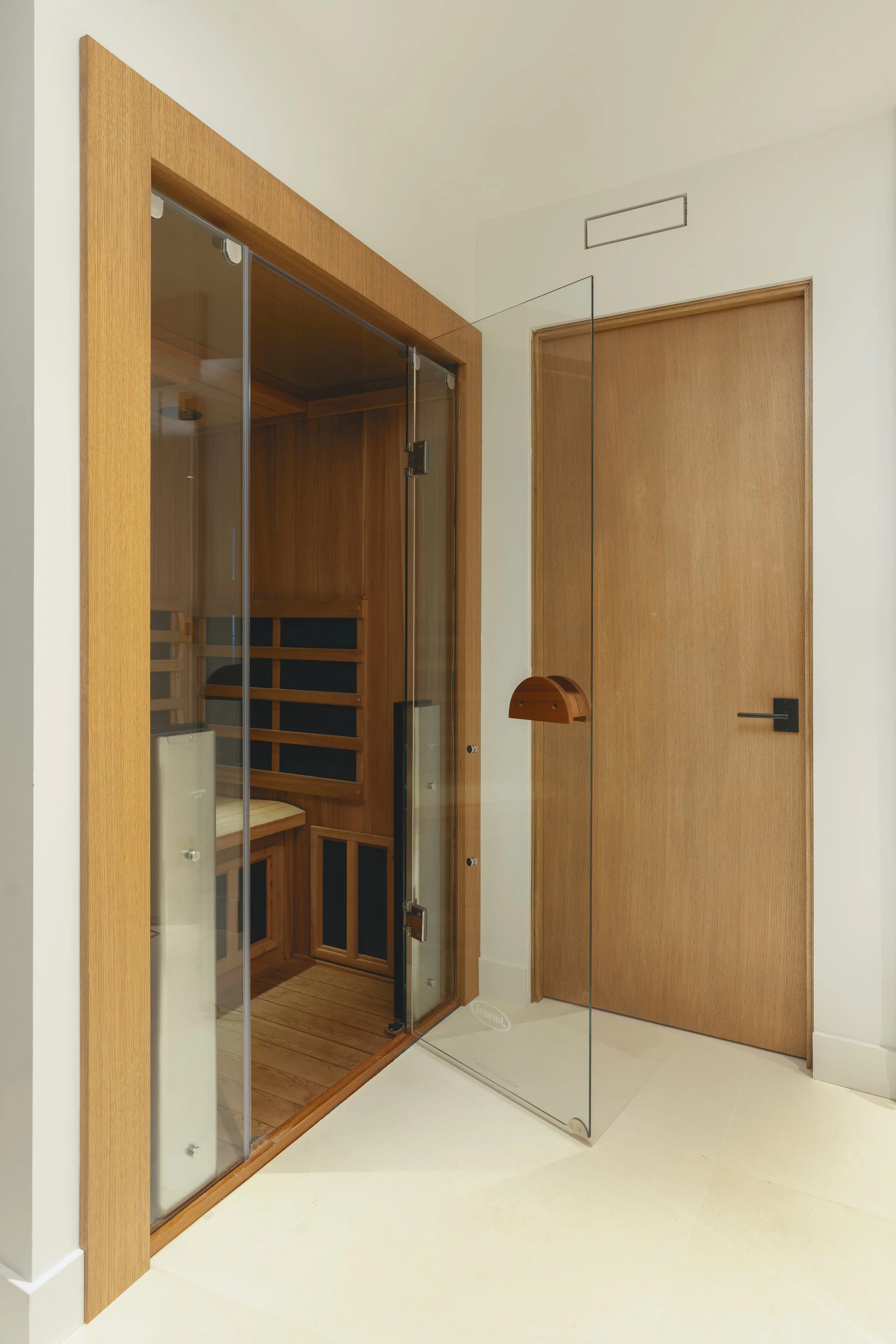 Jonathons Coastal Living interior design custom primary bathroom with sauna remodel showcasing luxury serene design with built in sauna in Dana Point, Orange County, CA