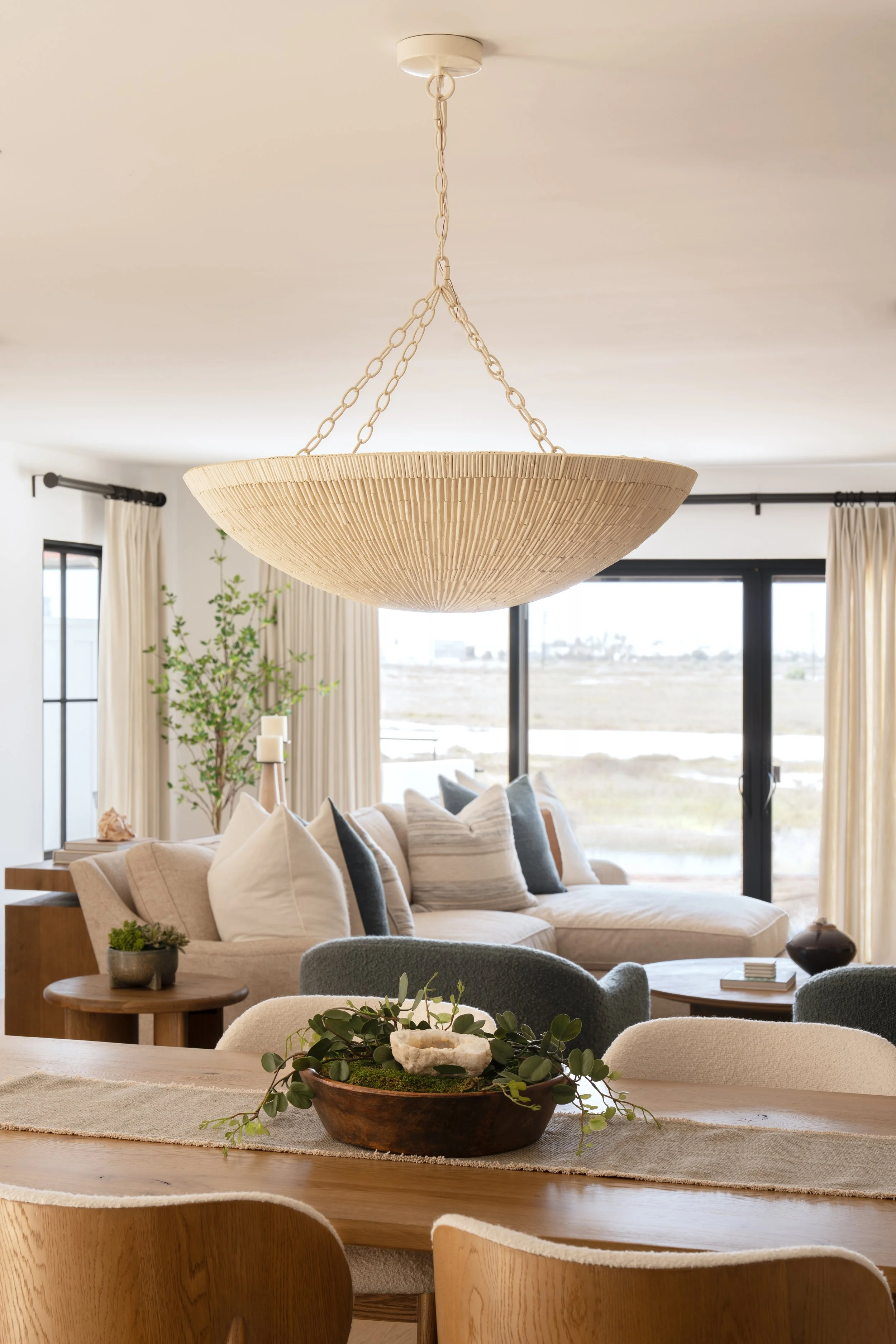 Coastal dining and living room highlighting Palecek Cora Chandelier in Newport Beach