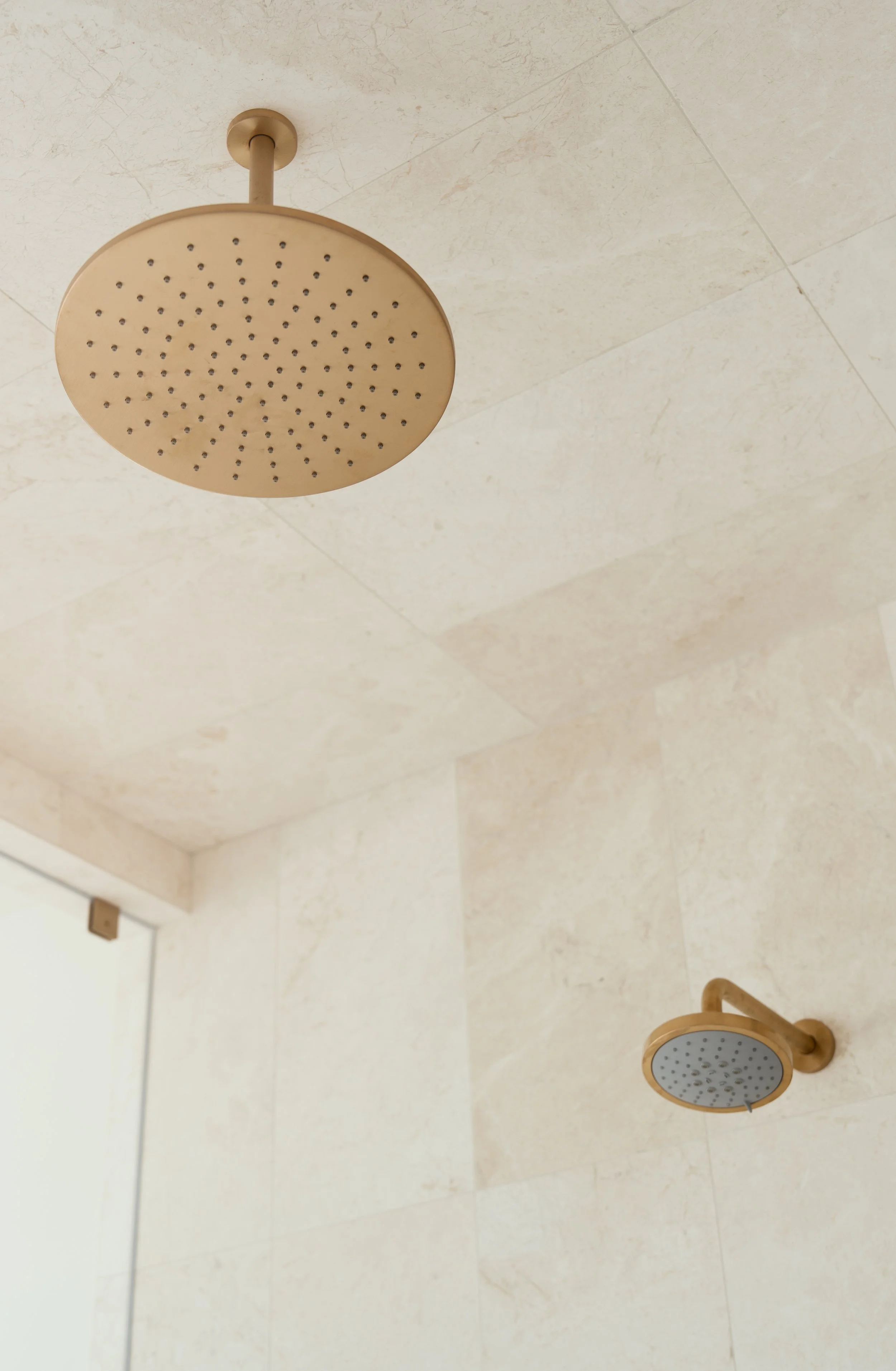 Jonathons Coastal Living interior design custom primary/master bathroom remodel in a simplistic traditional style showcasing a waterfall shower head in Dana Point, Orange County, CA