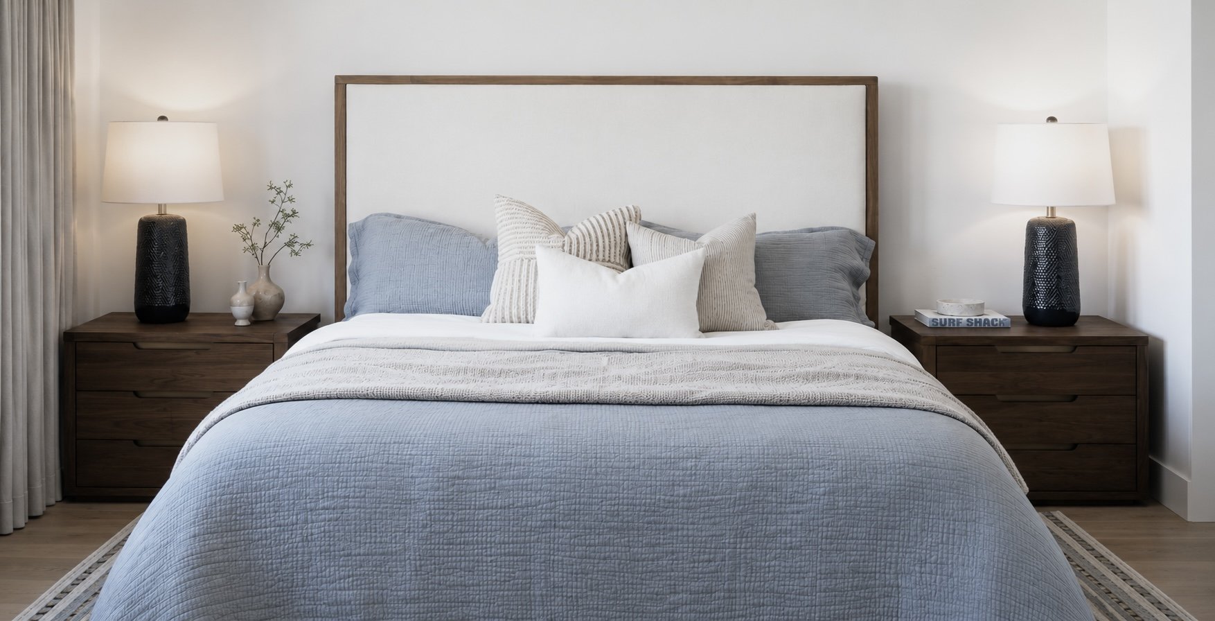 Relaxed coastal primary/master bedroom with blue bedding in Newport Beach