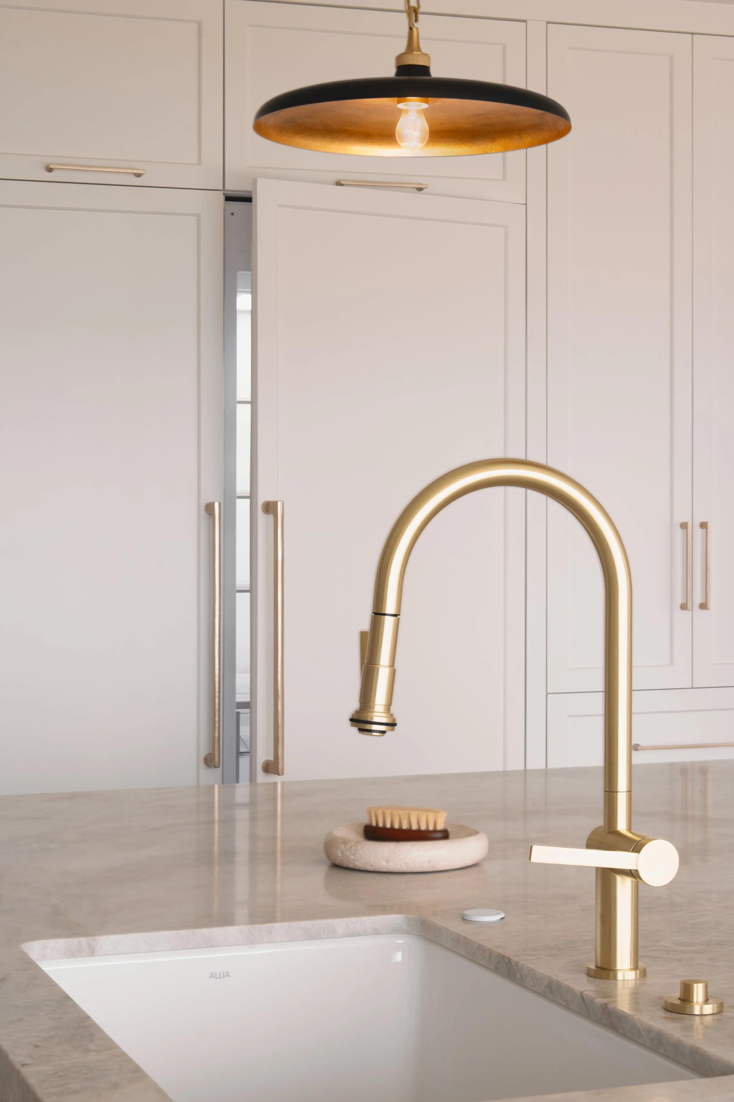 Brass faucet in white and grey tone kitchen