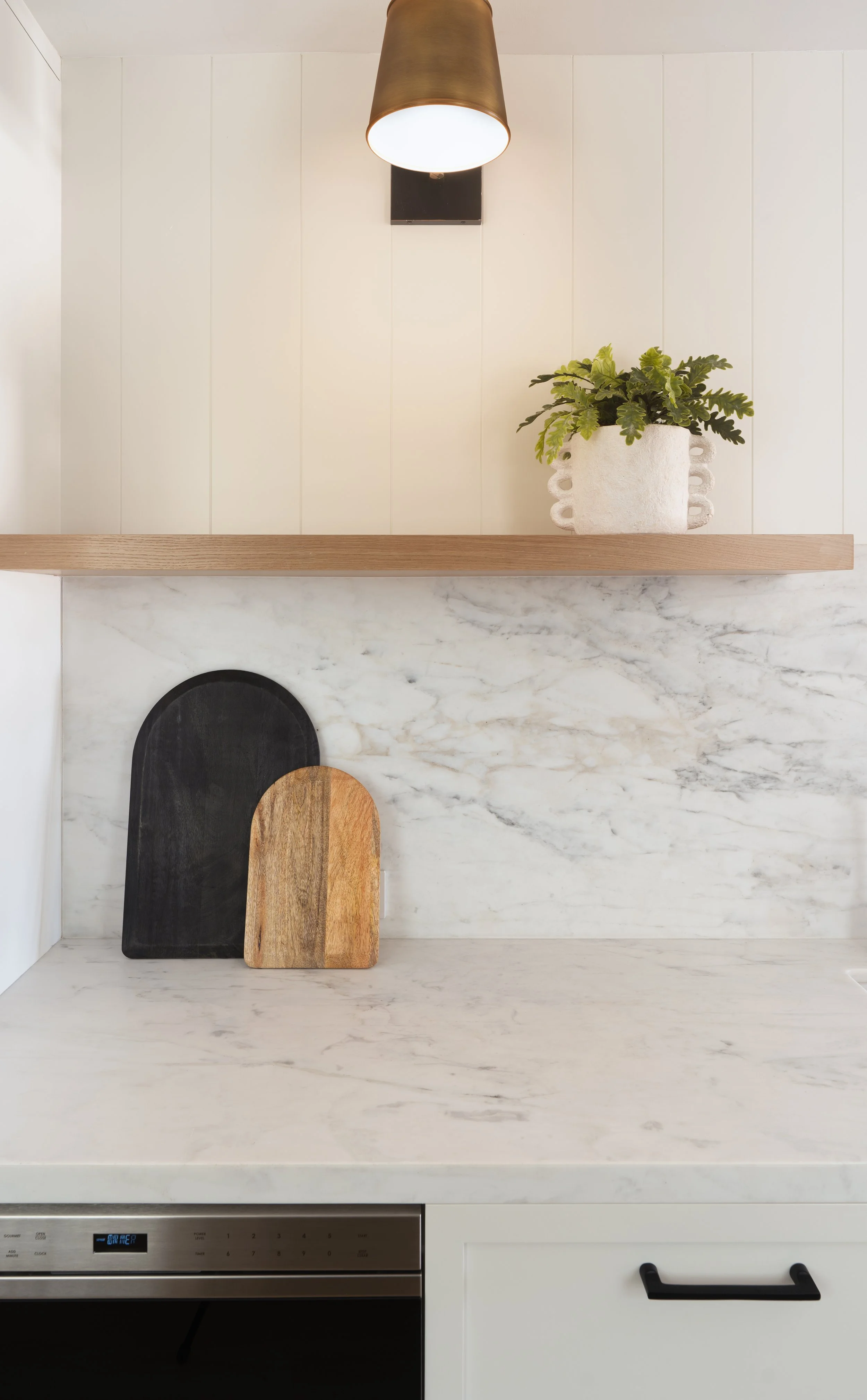 Kitchen remodel with floating shelf and library light in Newport Beach, CA