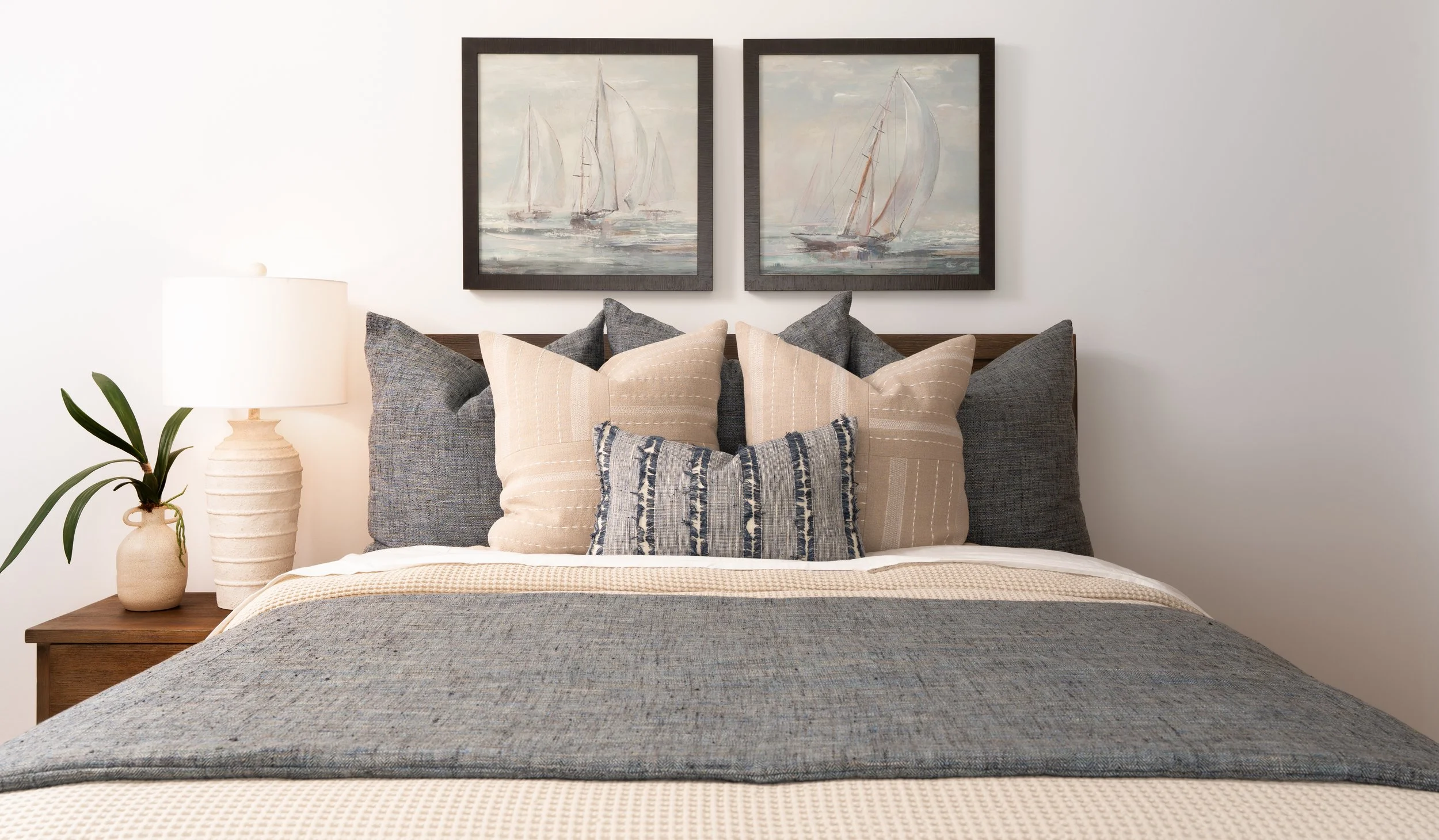 Coastal guest bedroom with sailboat art in Newport Beach