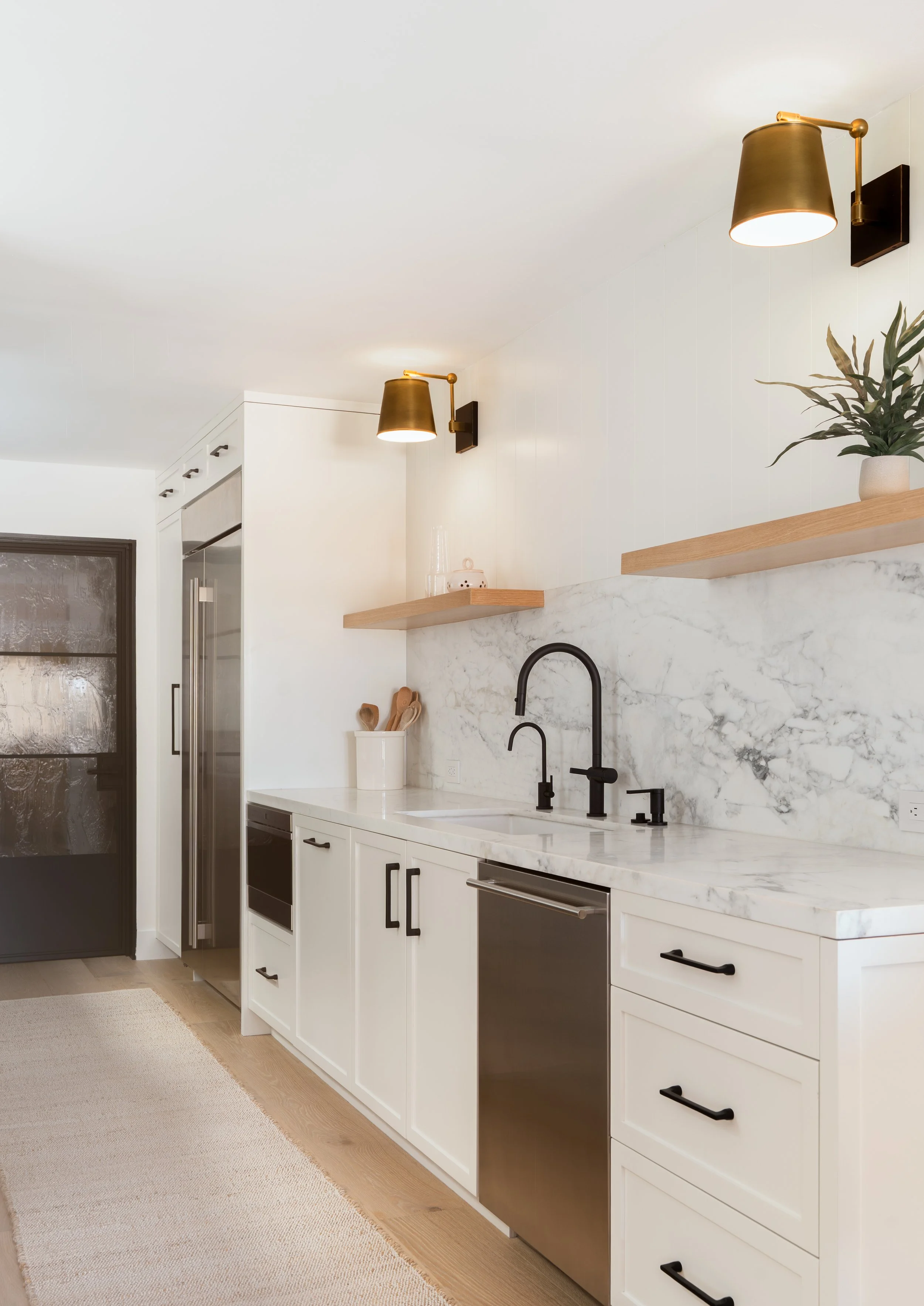 White galley kitchen remodel with floating shelves in Newport Beach, CA