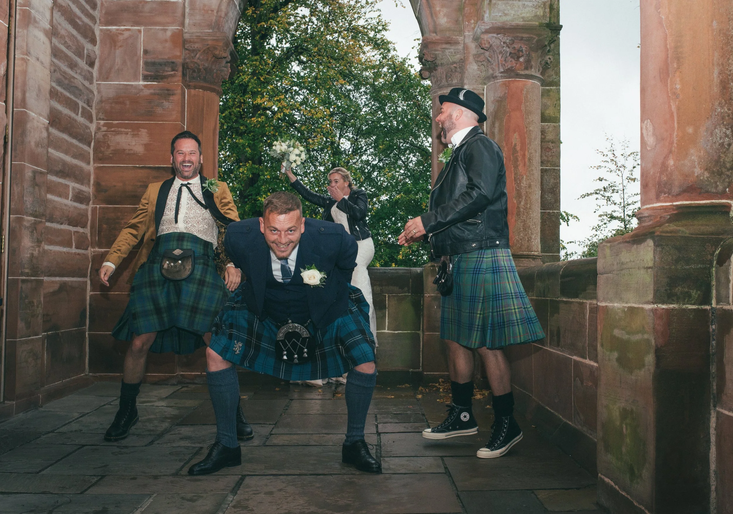 Groom and his friends having fun together outside the wedding venue