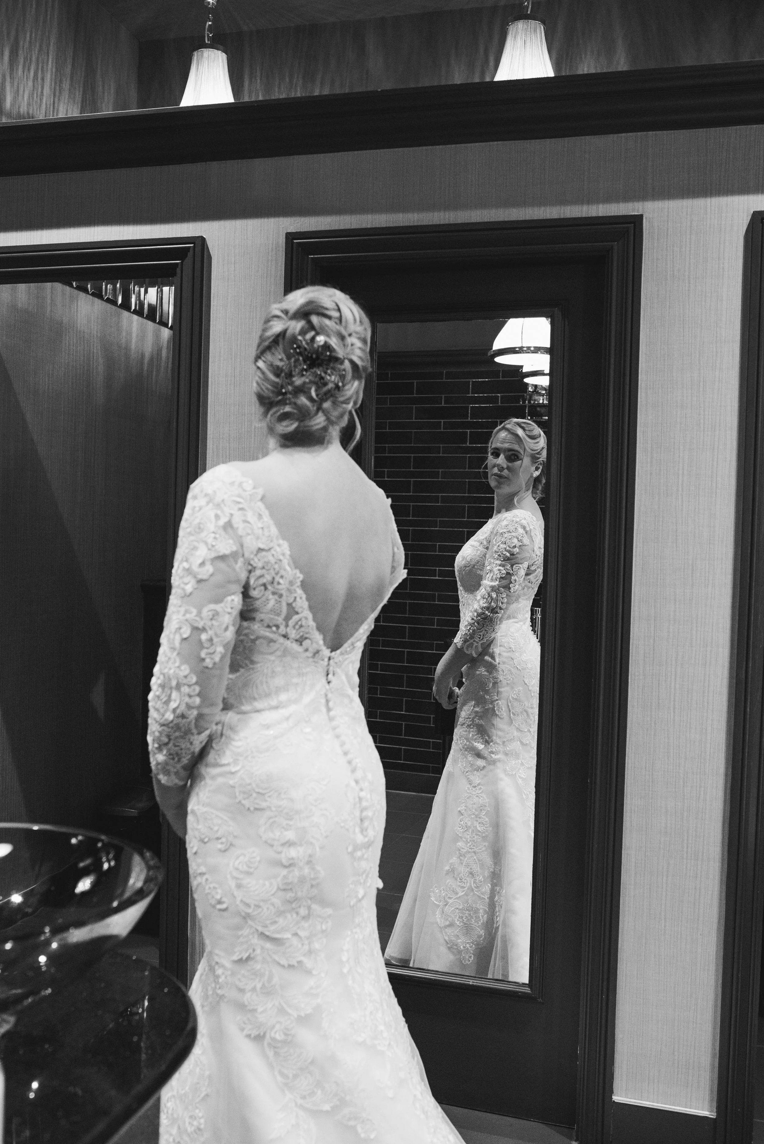Bride admiring her reflection in the mirror