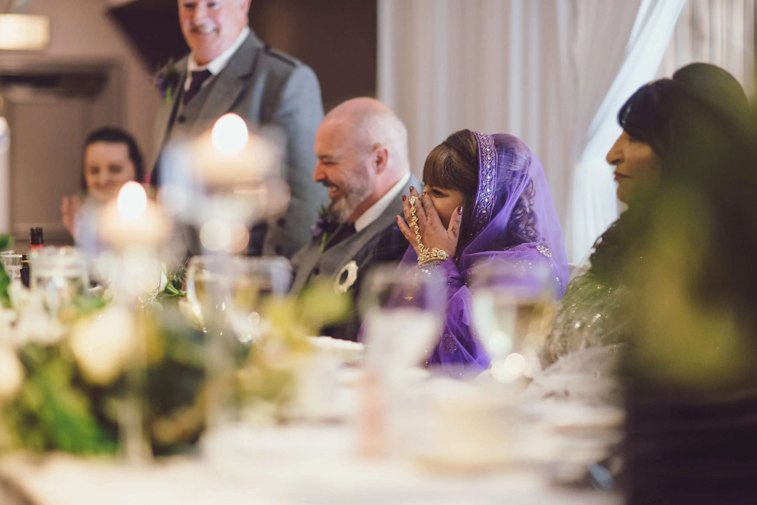 South Asian bride laughing with wedding guests during the reception