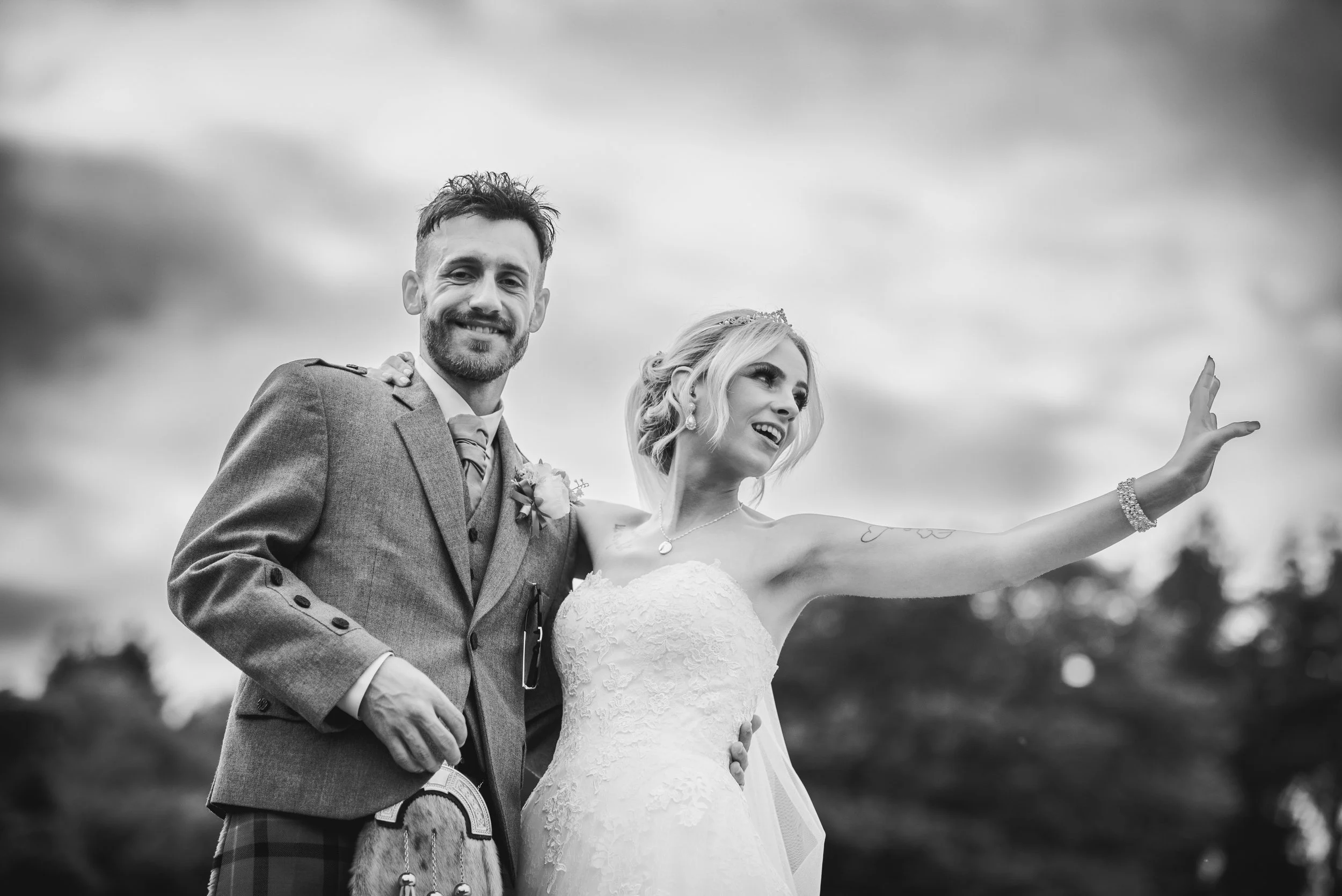 Newlywed couple laughing together during relaxed outdoor wedding portraits